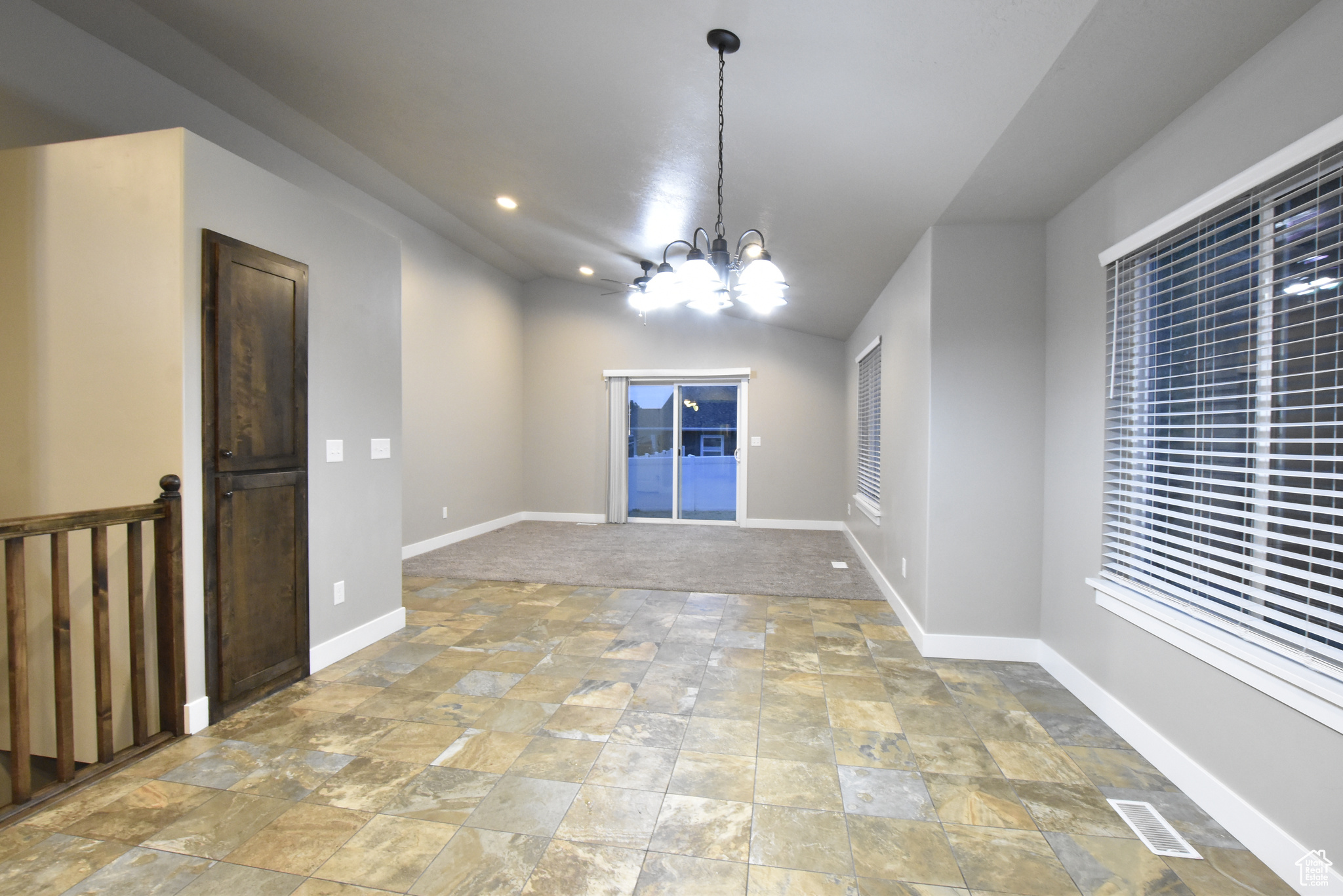 Unfurnished dining area with tile patterned floors and an inviting chandelier