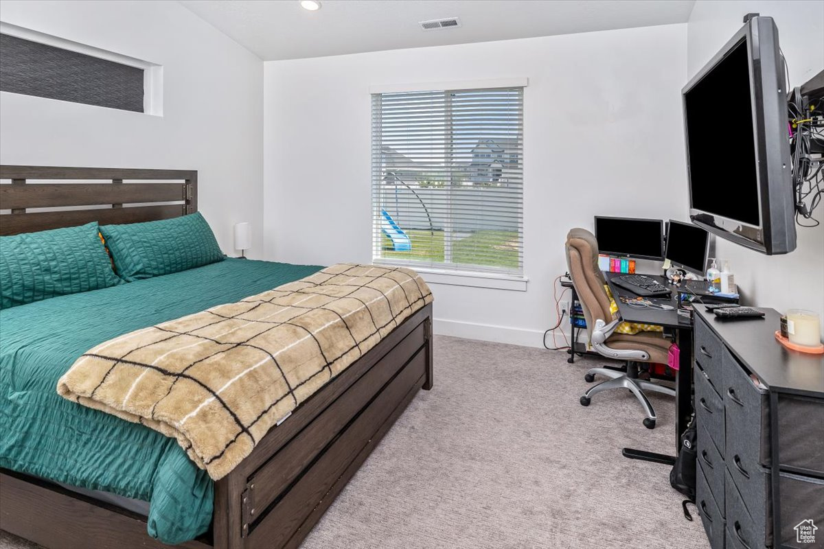 Bedroom featuring light colored carpet