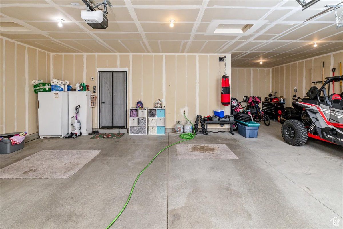 Garage featuring a garage door opener