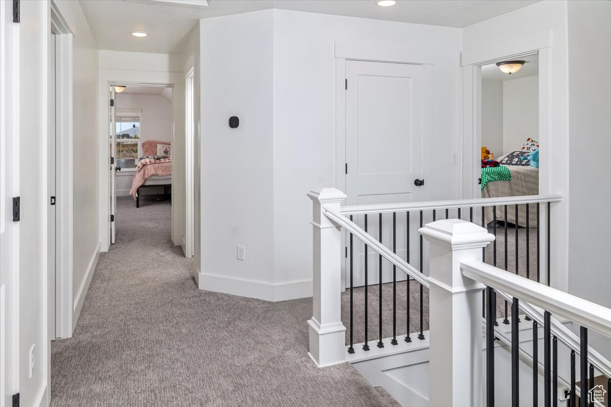 Hall featuring light colored carpet