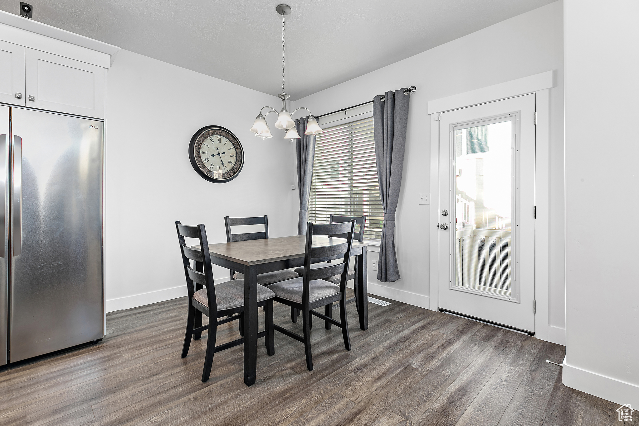 Dining room featuring an inviting chandelier and wood-style flooring