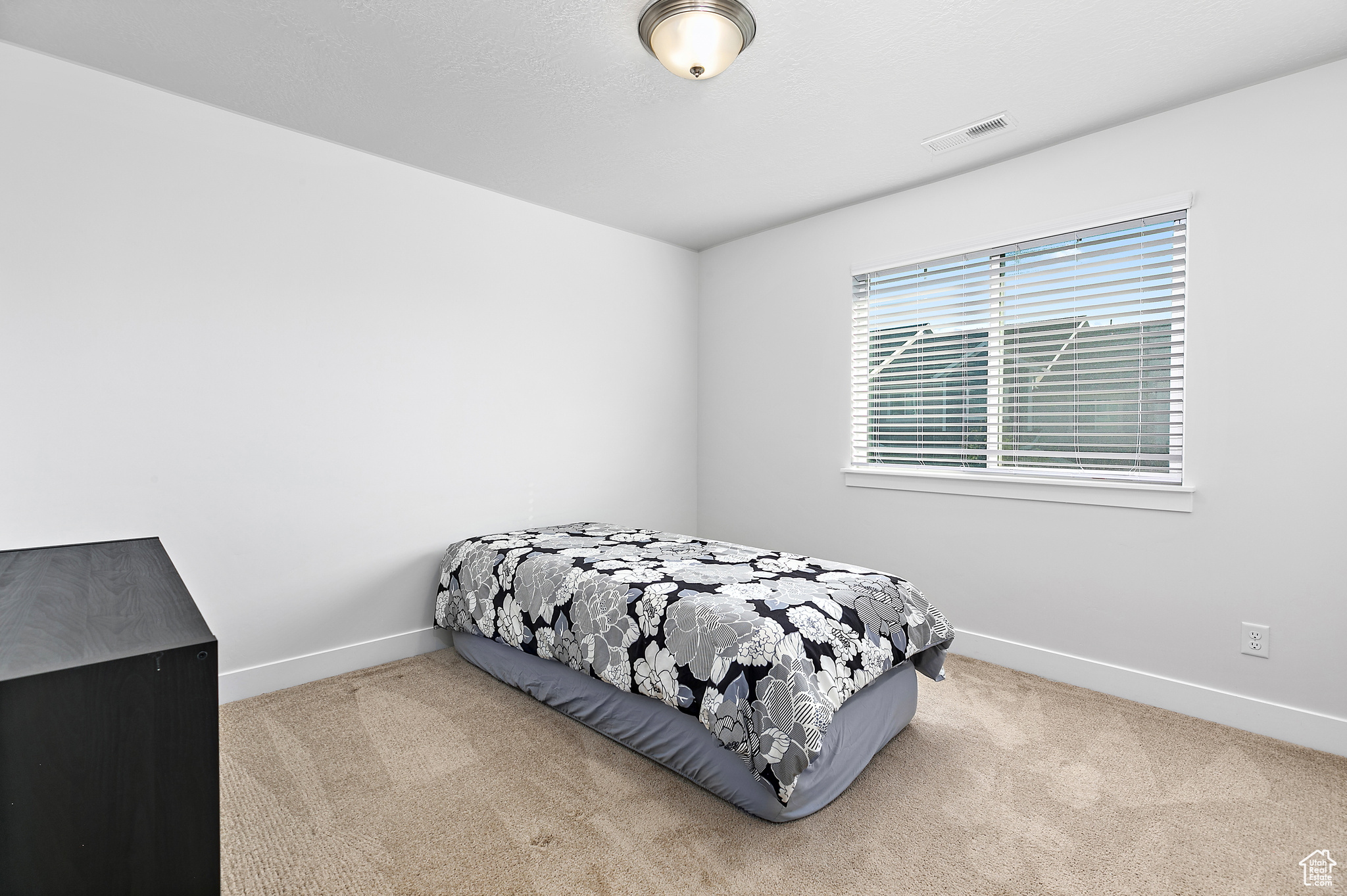 Bedroom with light colored carpet