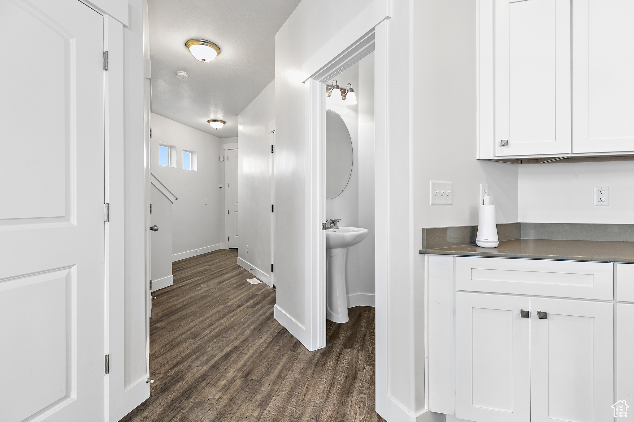 Corridor featuring wood-style flooring