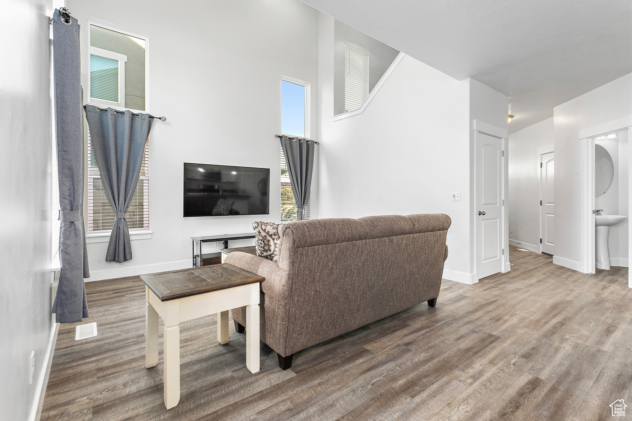 Living room with dark wood-type flooring