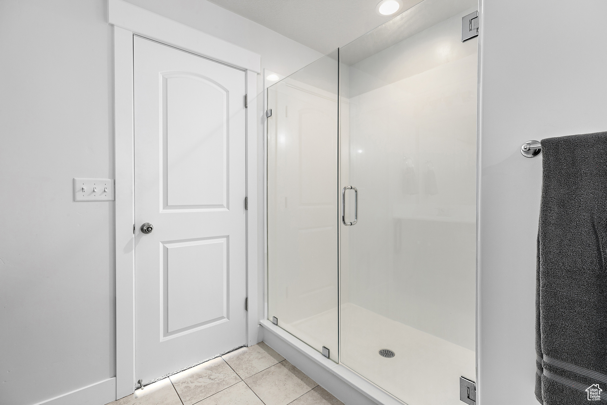 Bathroom with an enclosed shower and tile patterned flooring / Re-Done shower that has been expanced