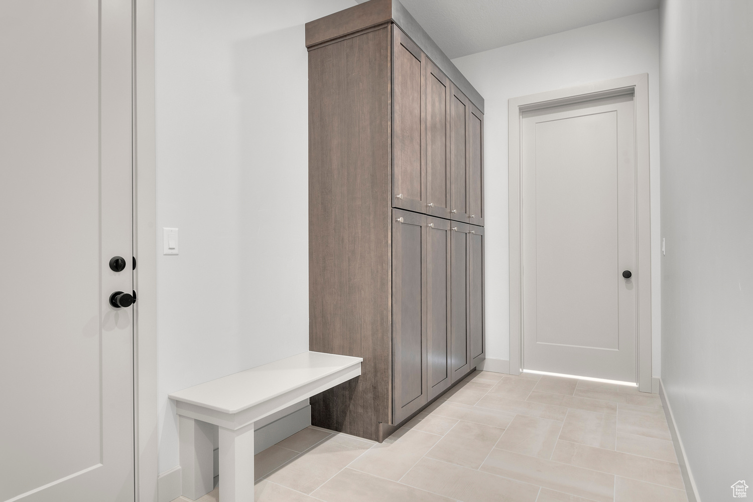 Mudroom with light tile patterned floors