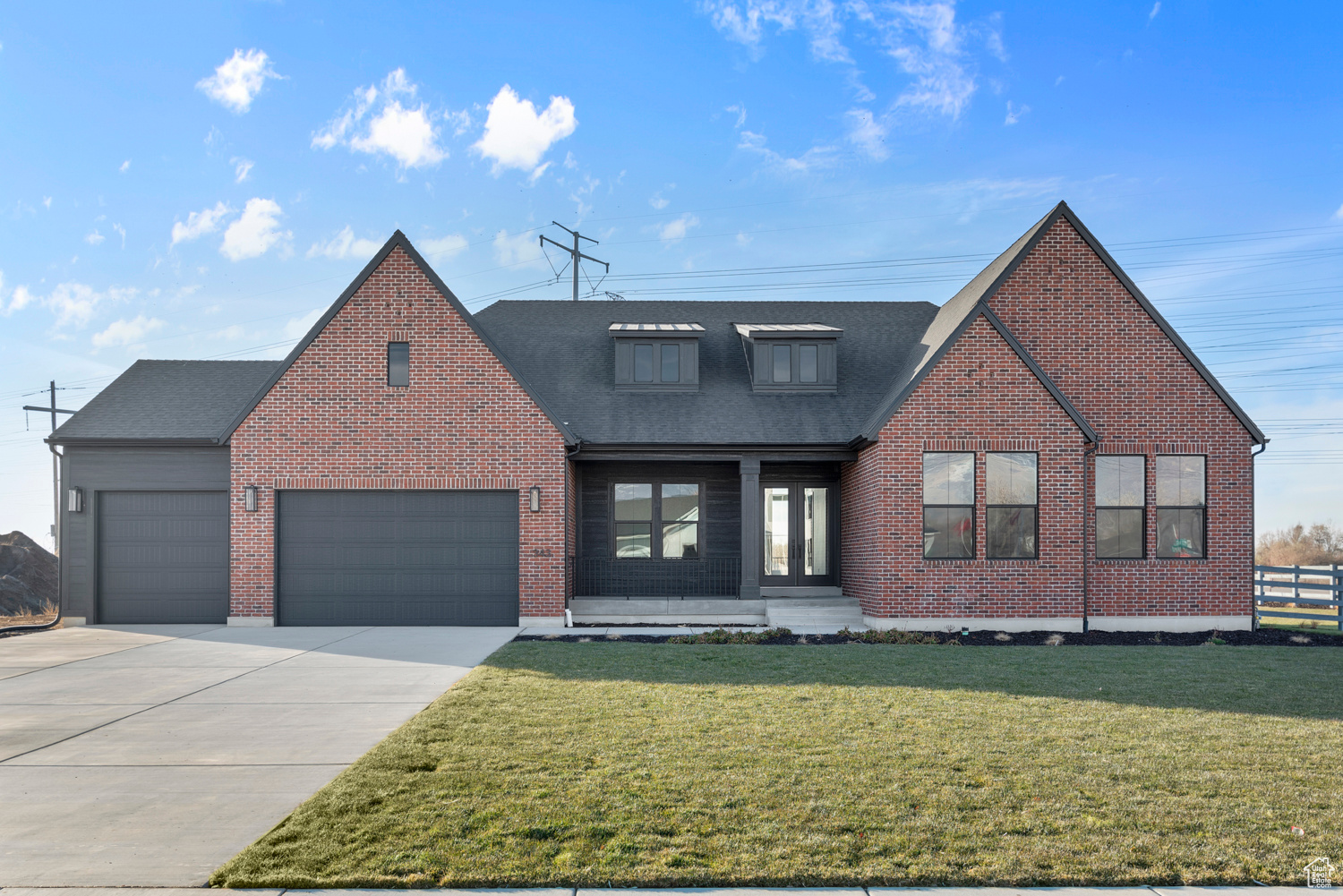 View of front of property with a garage and a front yard