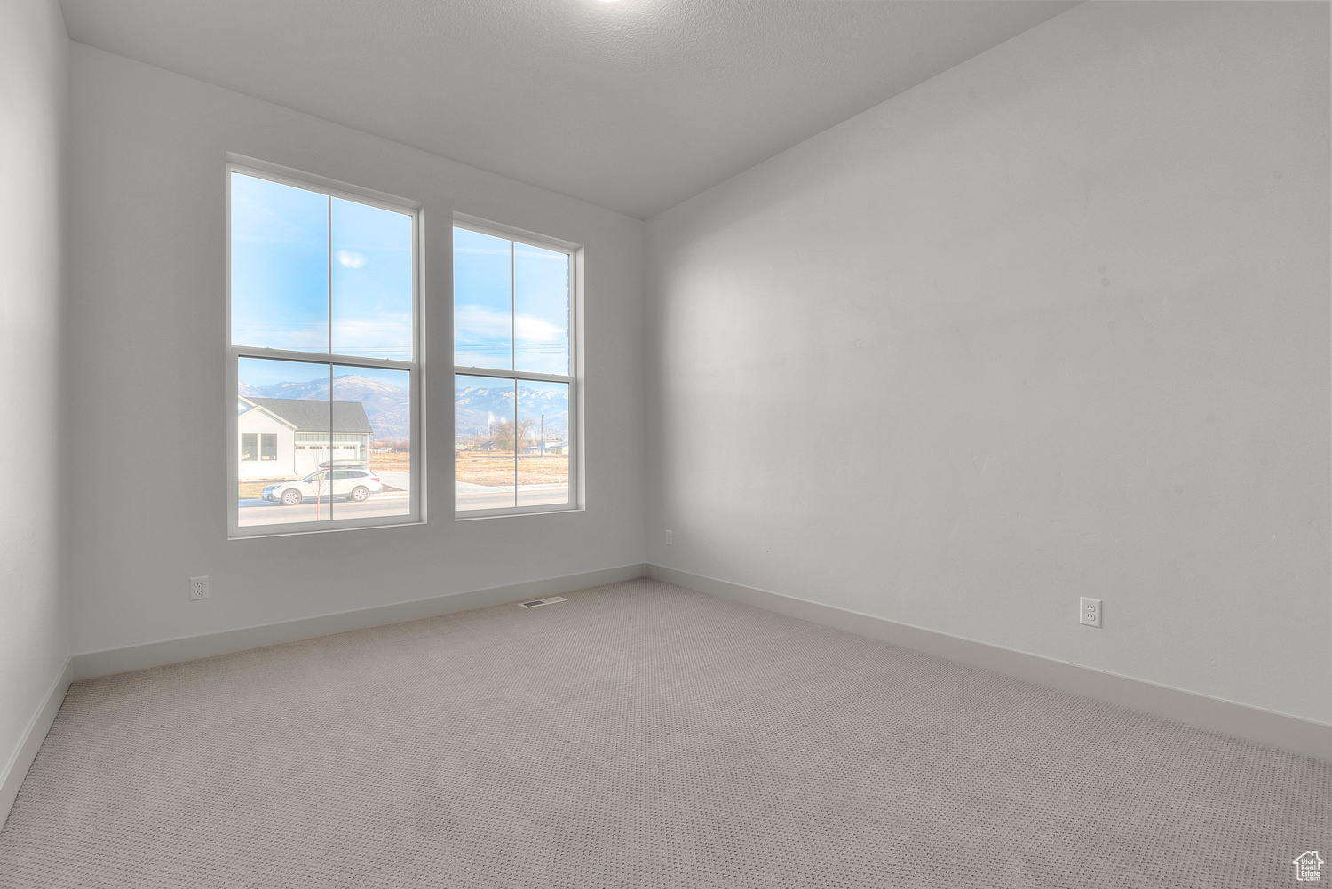 Spare room featuring light colored carpet