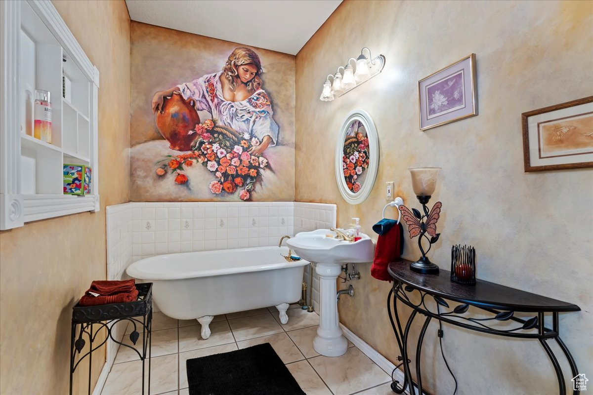 Bathroom with tile patterned floors and a bath