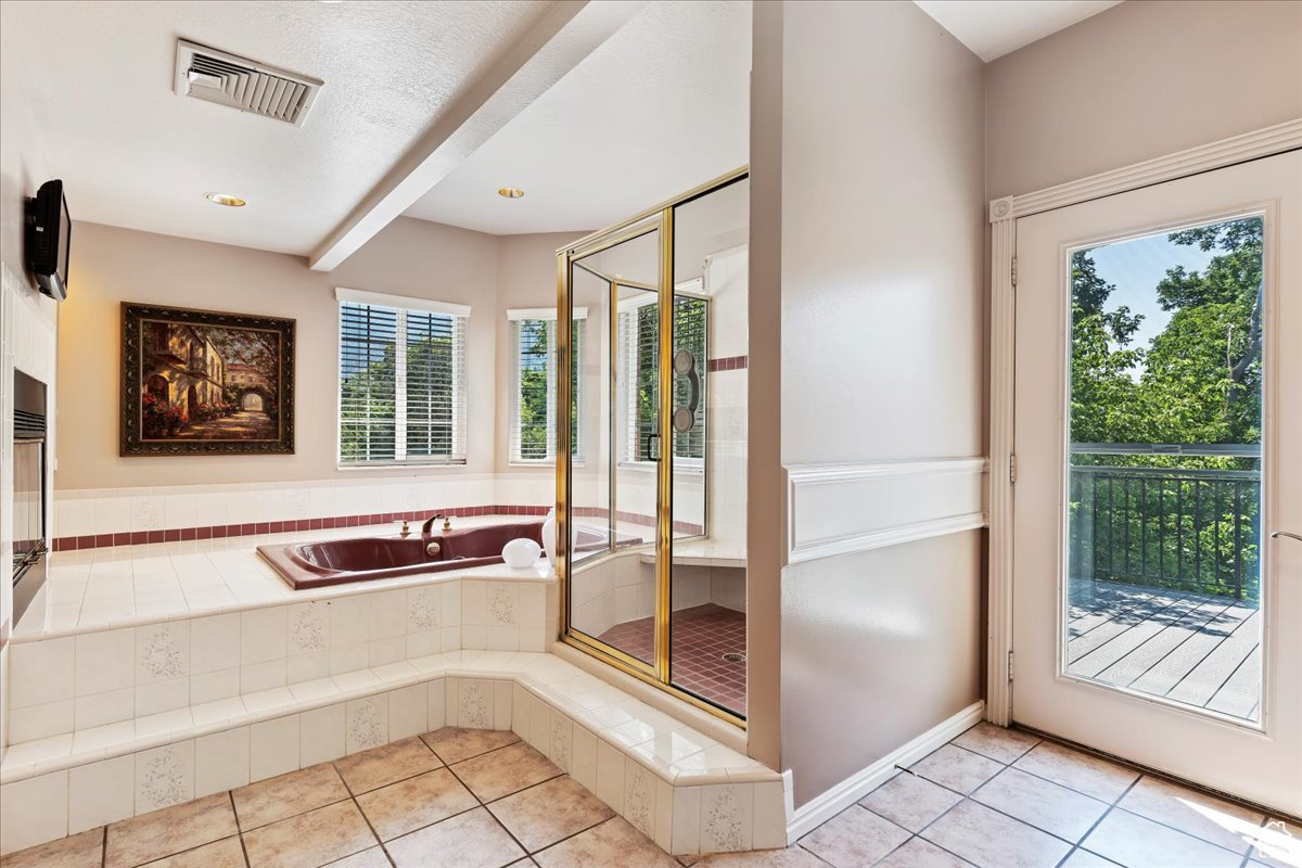 Doorway featuring light tile patterned floors