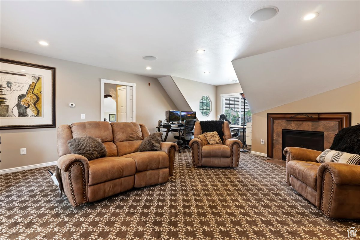 Carpeted living room with a fireplace