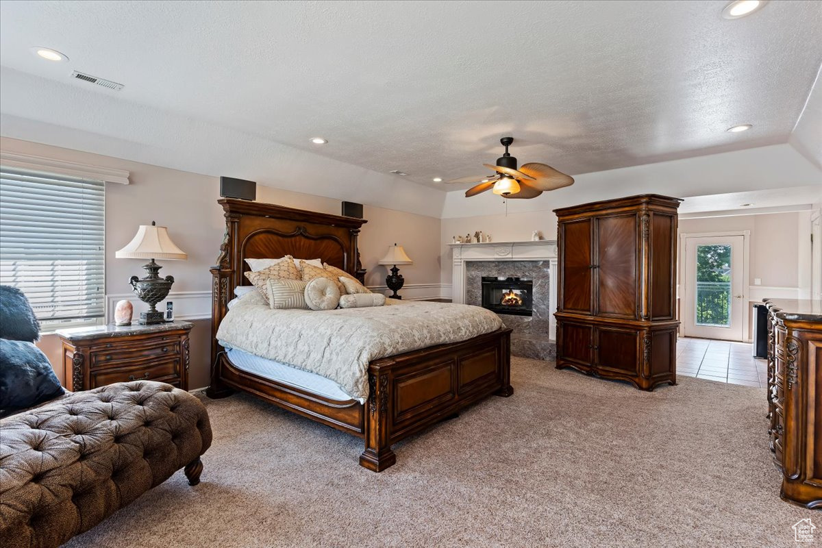 Bedroom with light colored carpet and ceiling fan