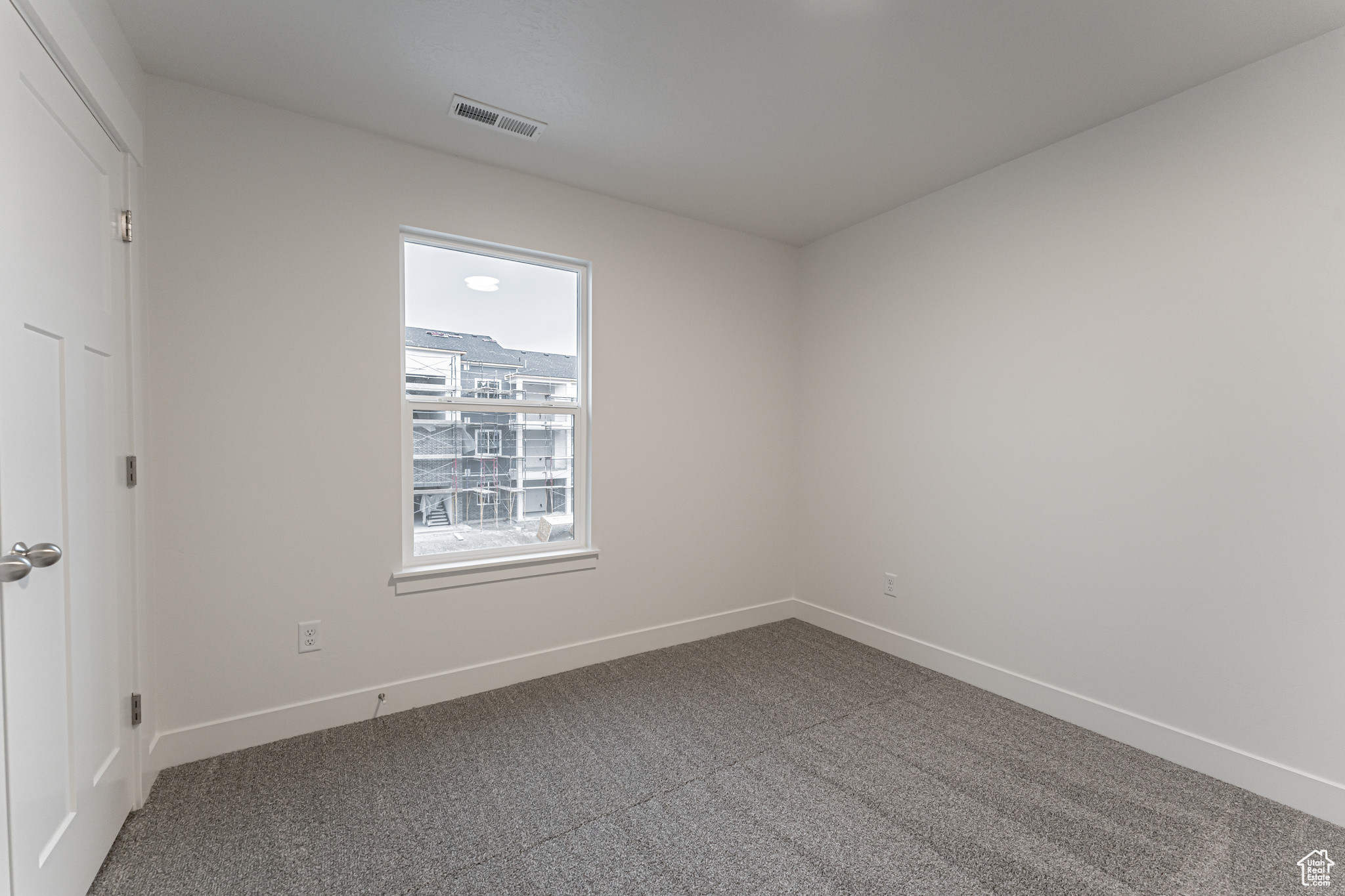 Empty room with carpet floors