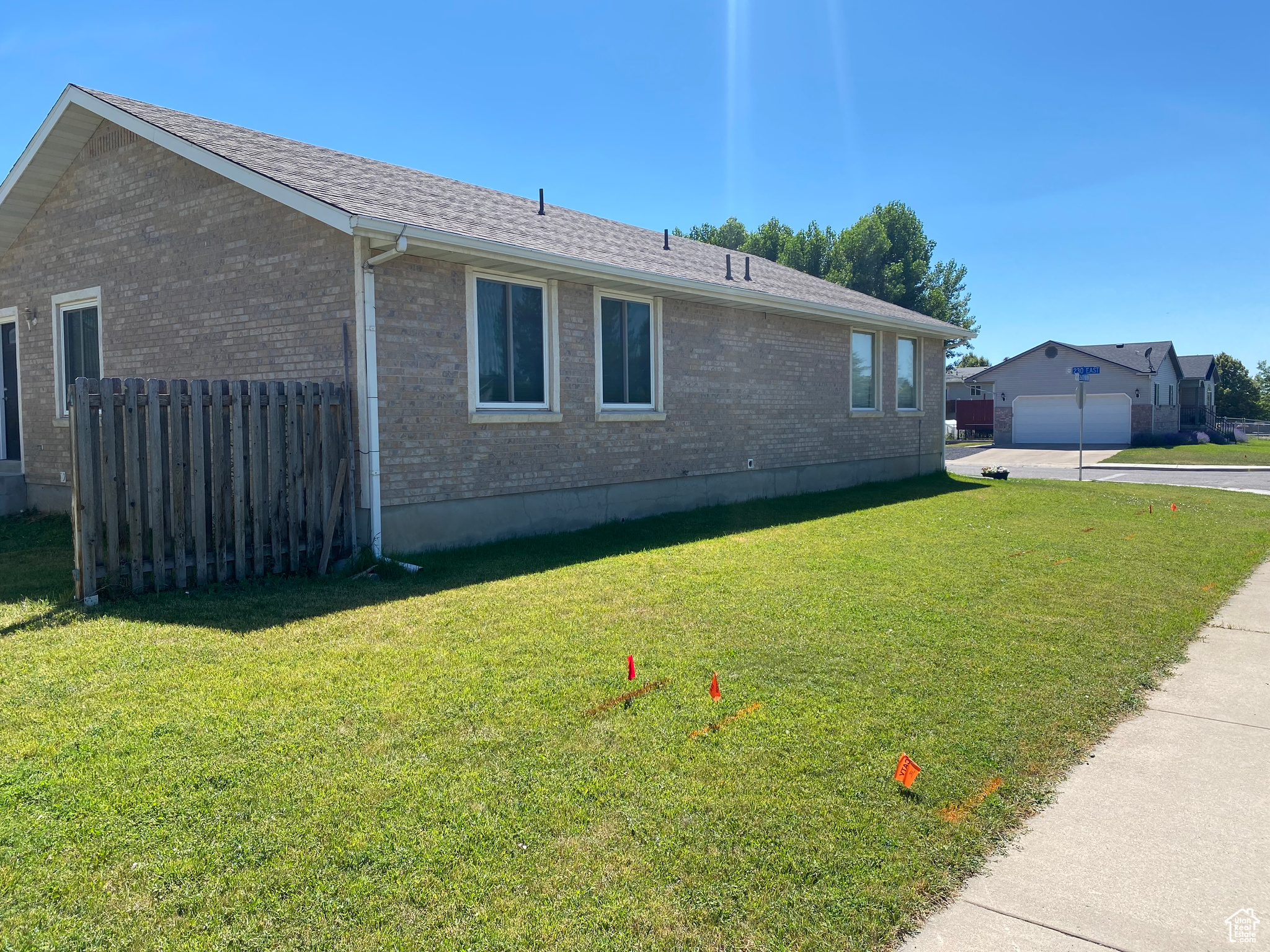 View of property exterior with a garage and a lawn