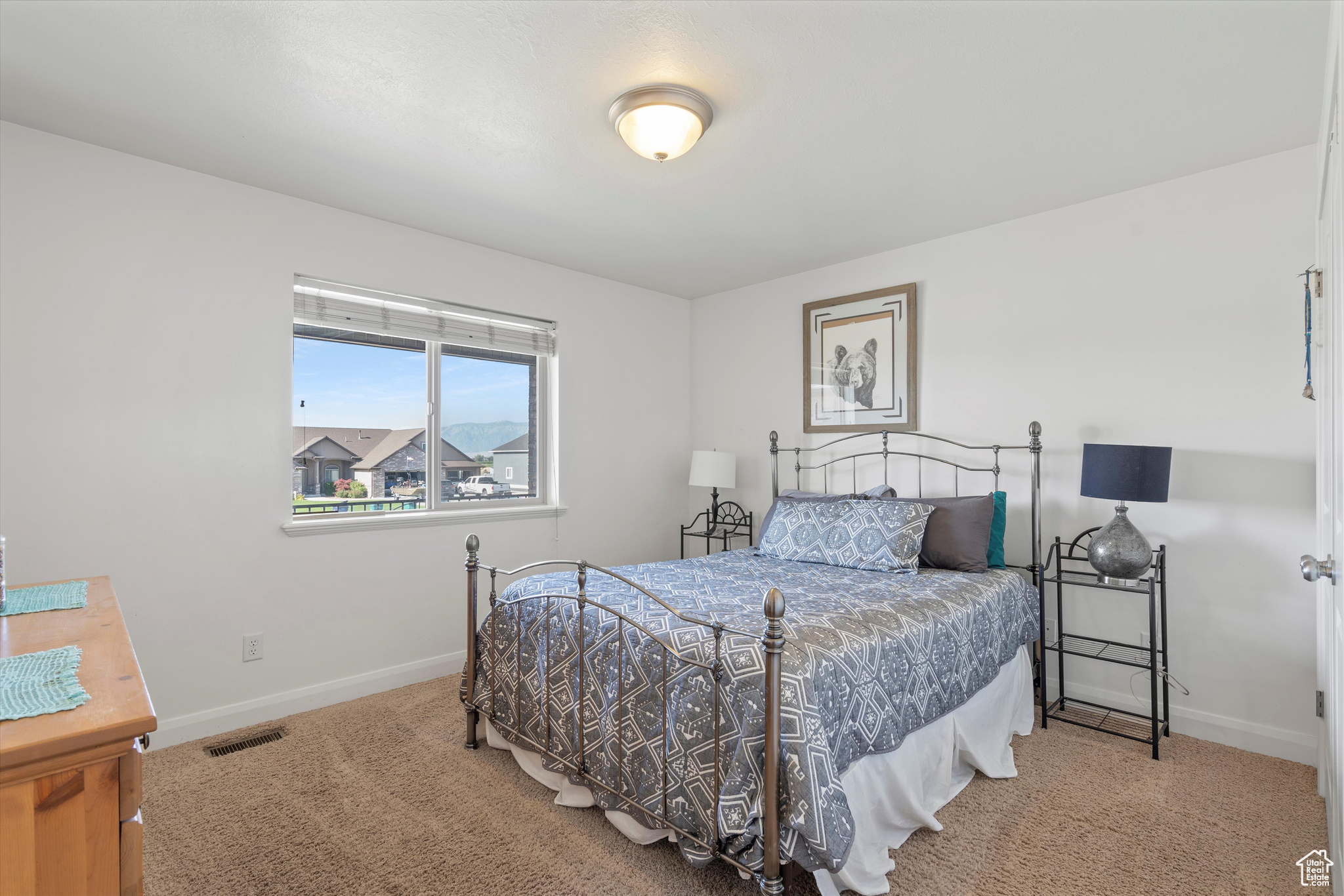 Bedroom featuring light colored carpet