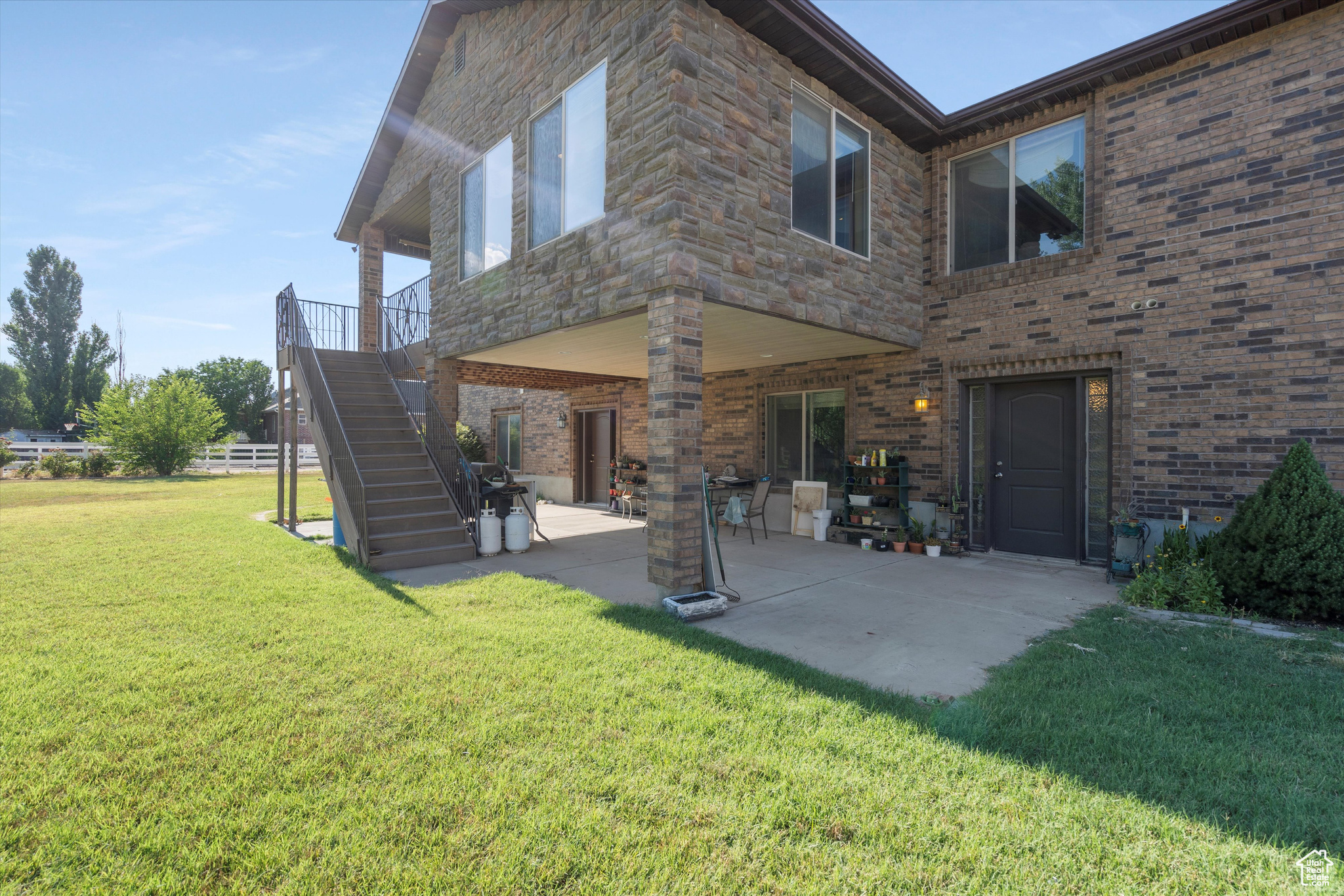 Rear view of house with a patio and a yard