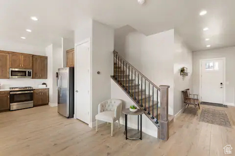 Kitchen featuring light wood-type flooring and stainless steel appliances