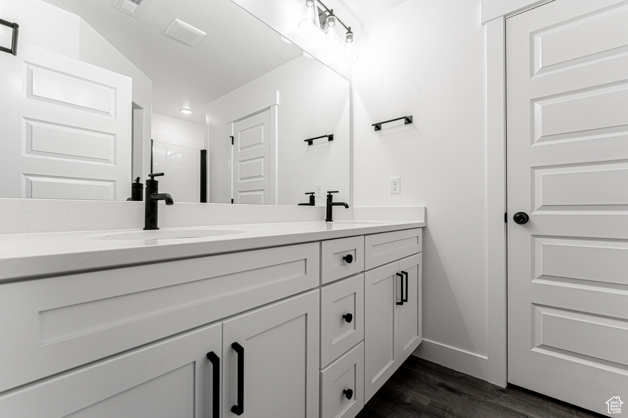 Bathroom with vanity and wood-type flooring