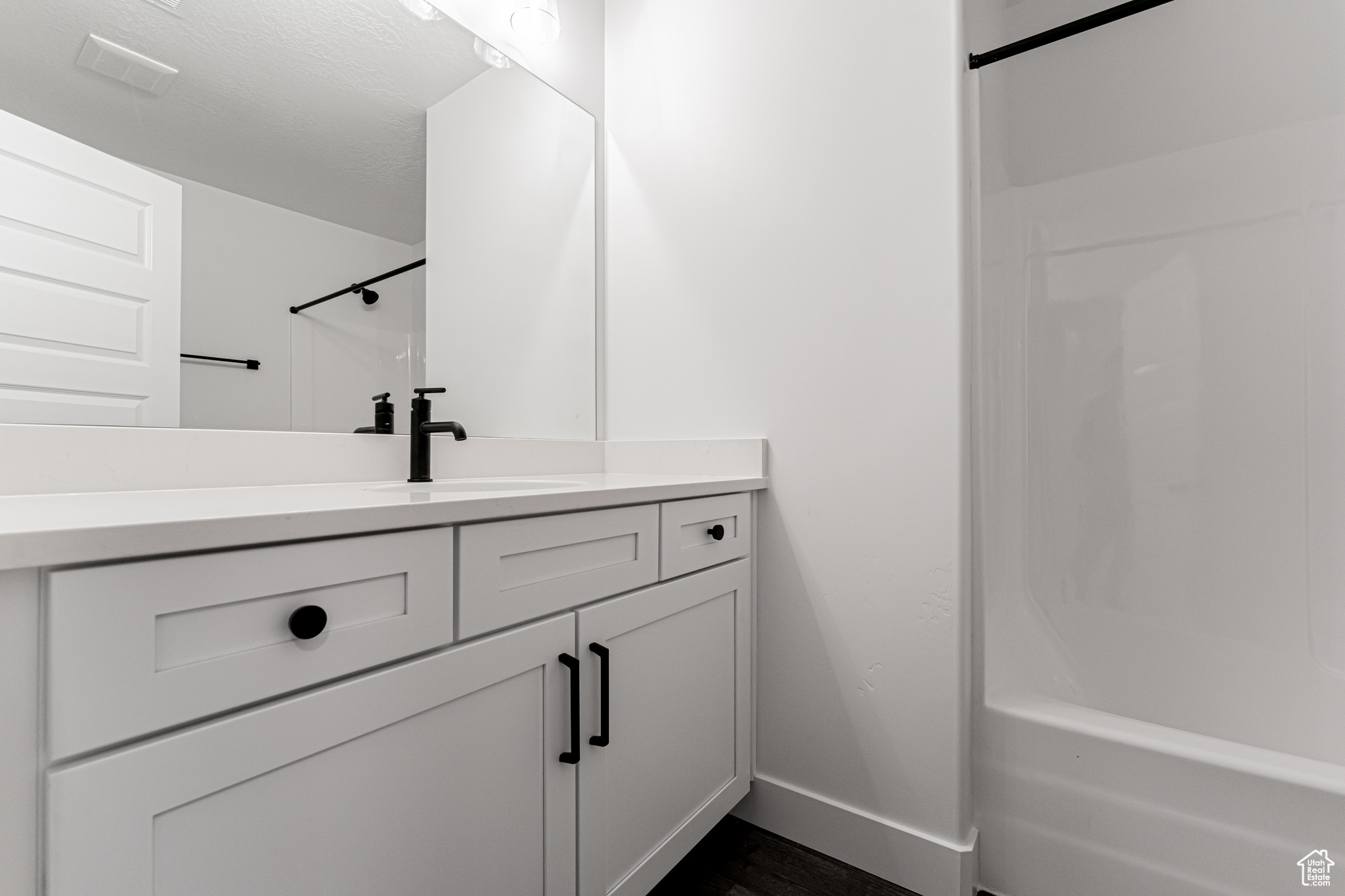 Bathroom with vanity and tub / shower combination