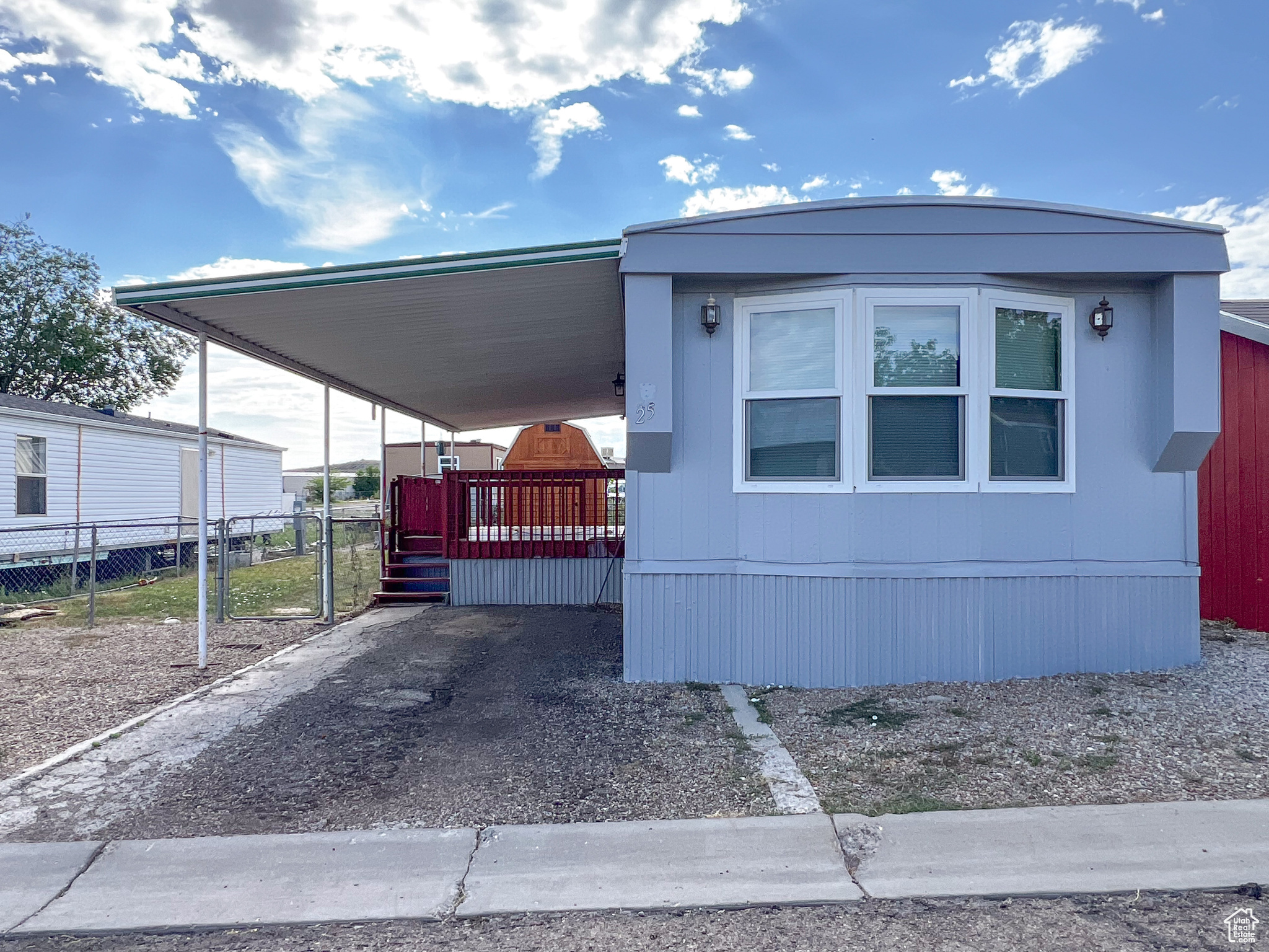 Manufactured / mobile home featuring a carport