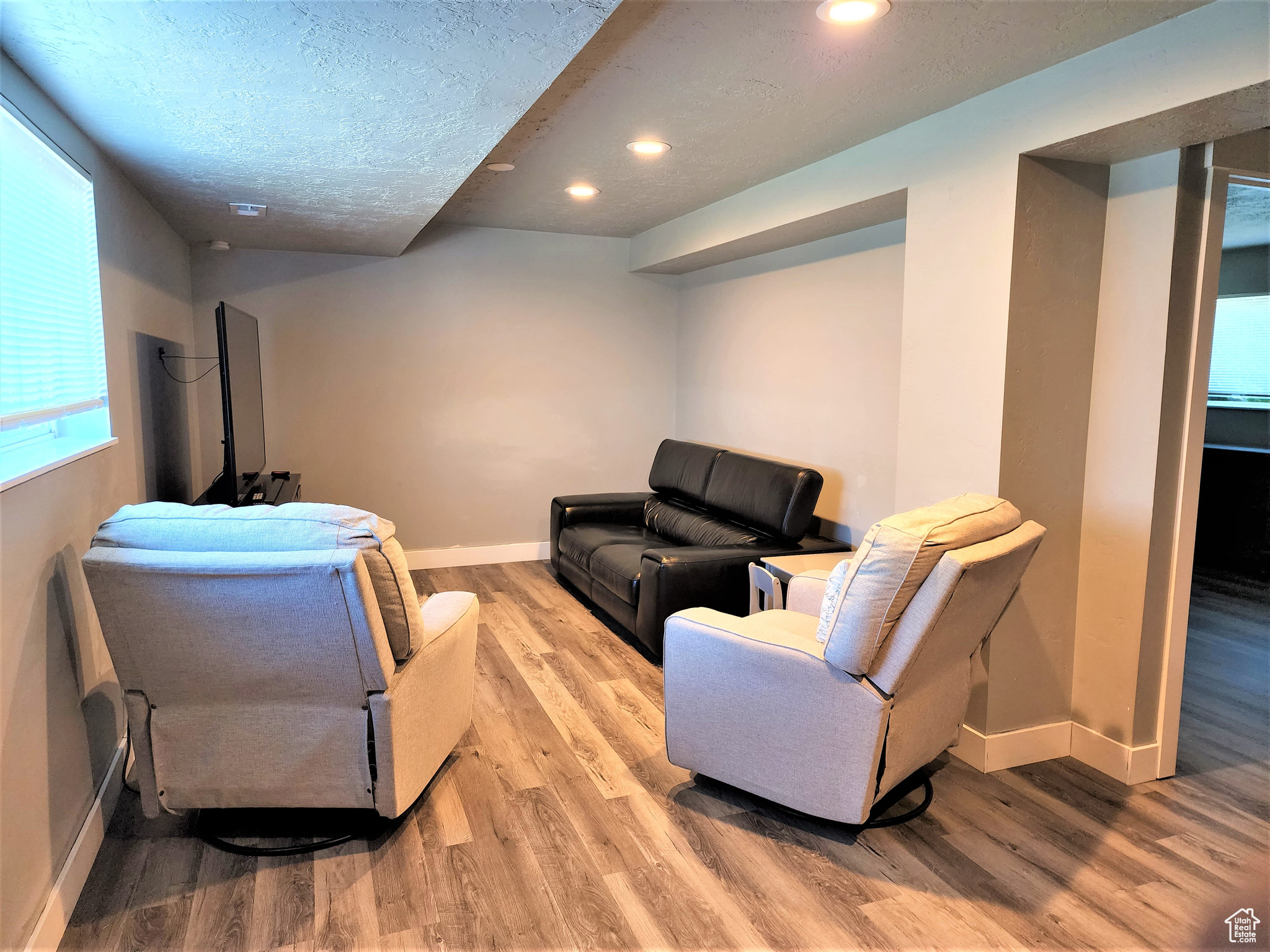 Living room featuring hardwood / wood-style flooring and a textured ceiling