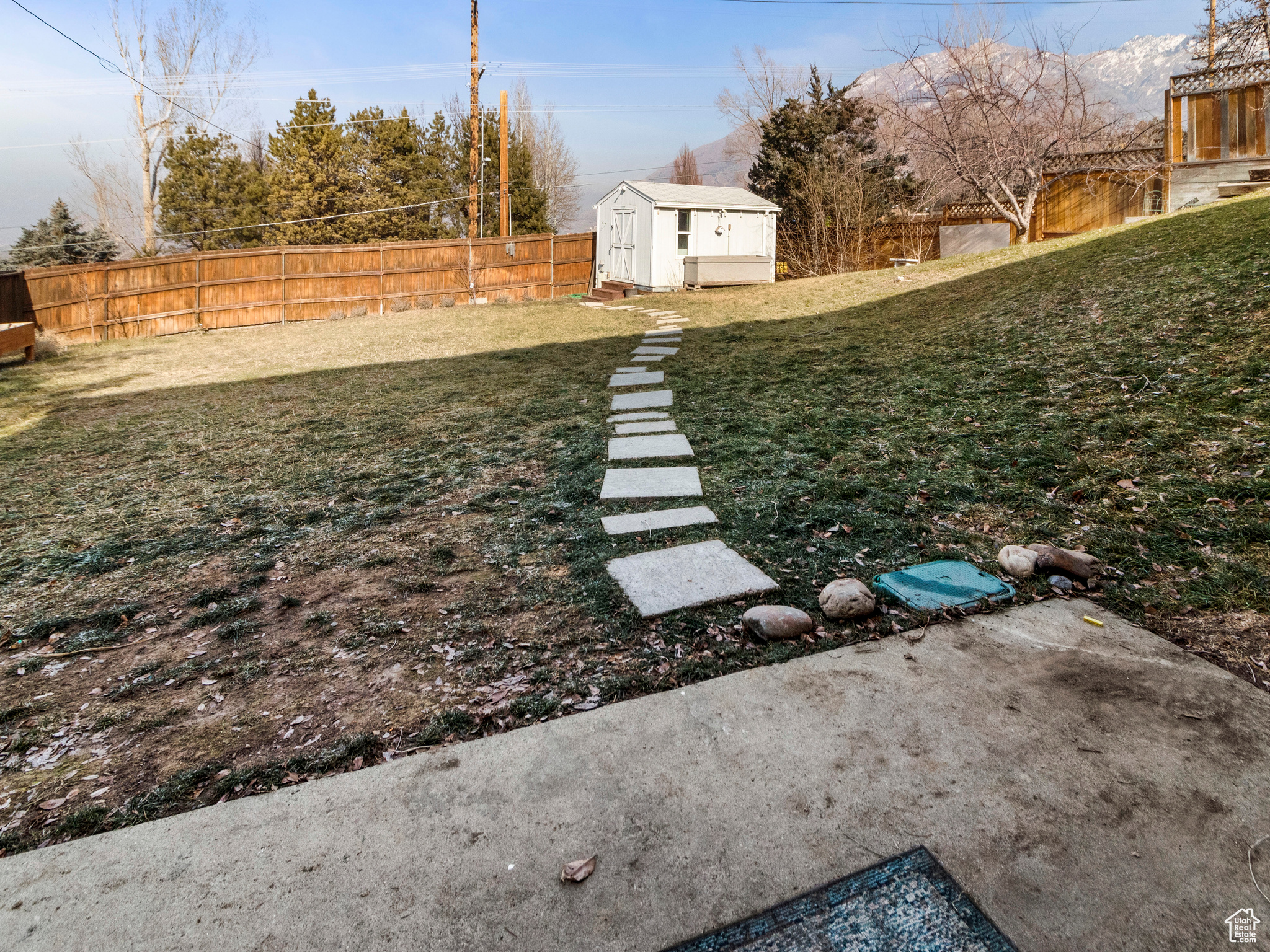 View of yard with a storage unit