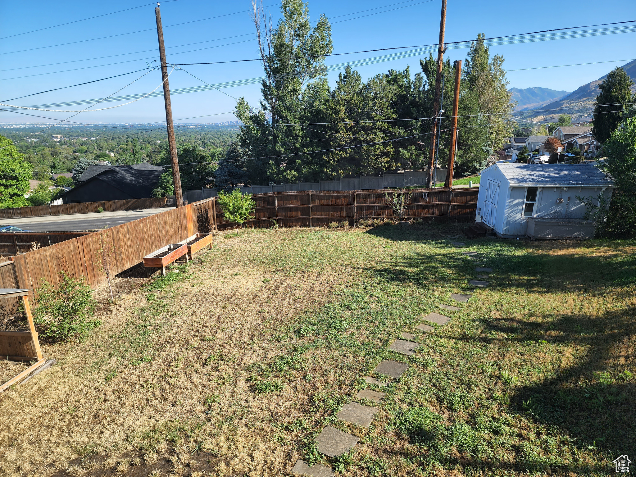 View of yard featuring a storage unit and a mountain view