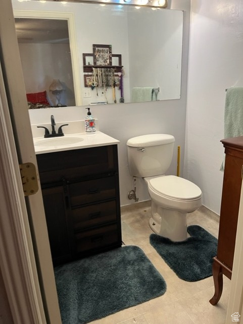 Master Bathroom with vanity, tile patterned flooring, and toilet