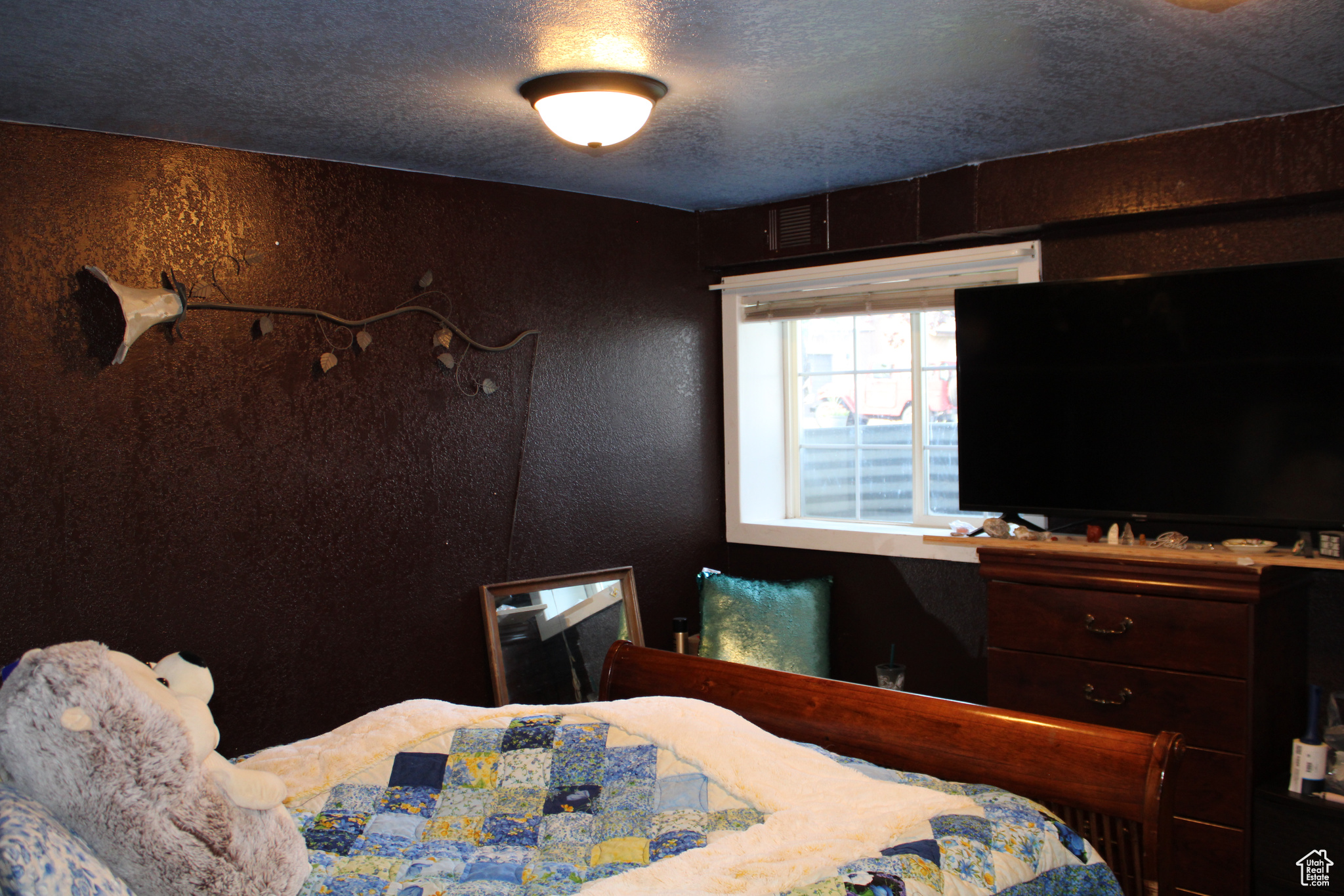 Bedroom featuring a textured ceiling.