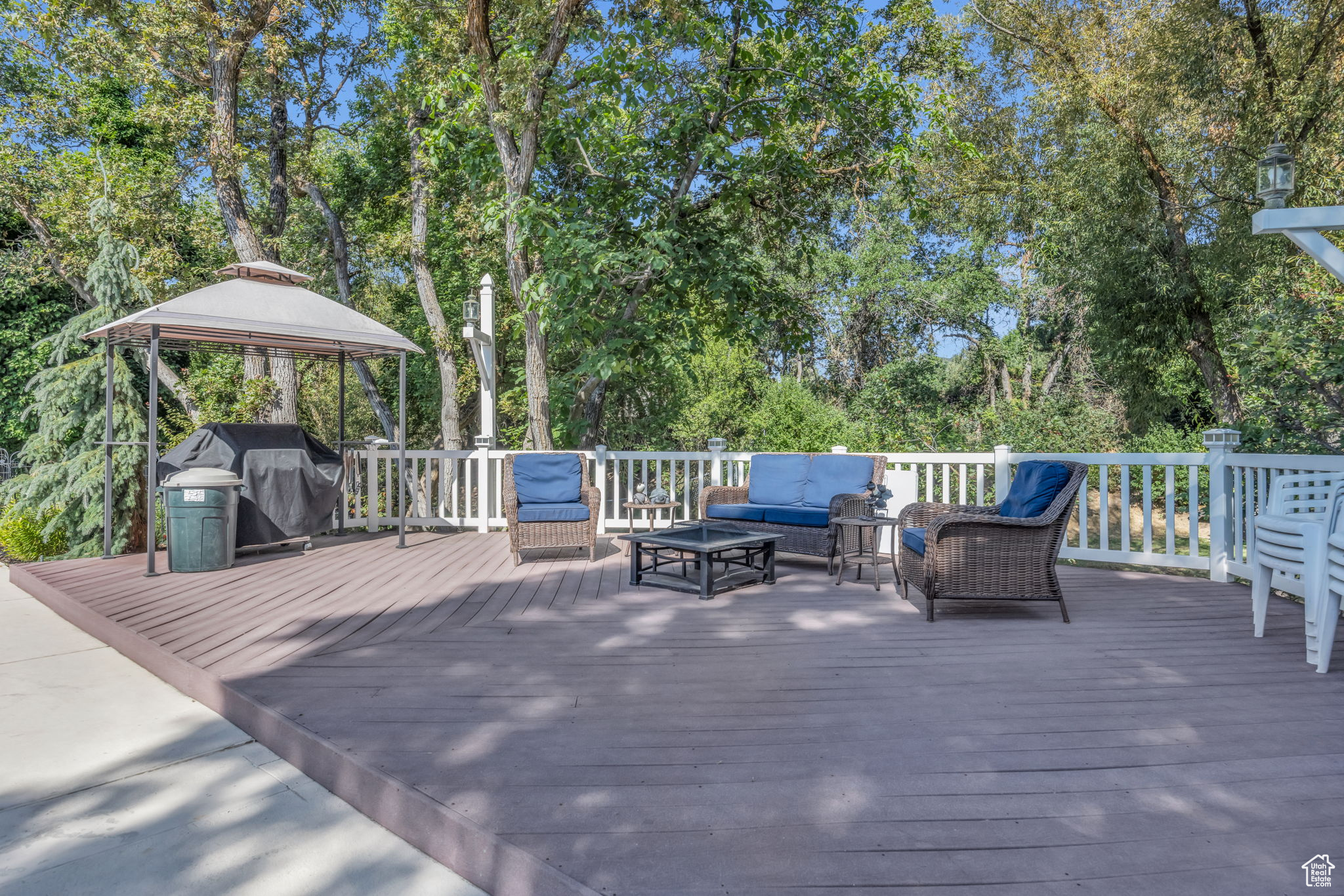 Pool area wooden terrace with grilling area, an outdoor living space, and a gazebo