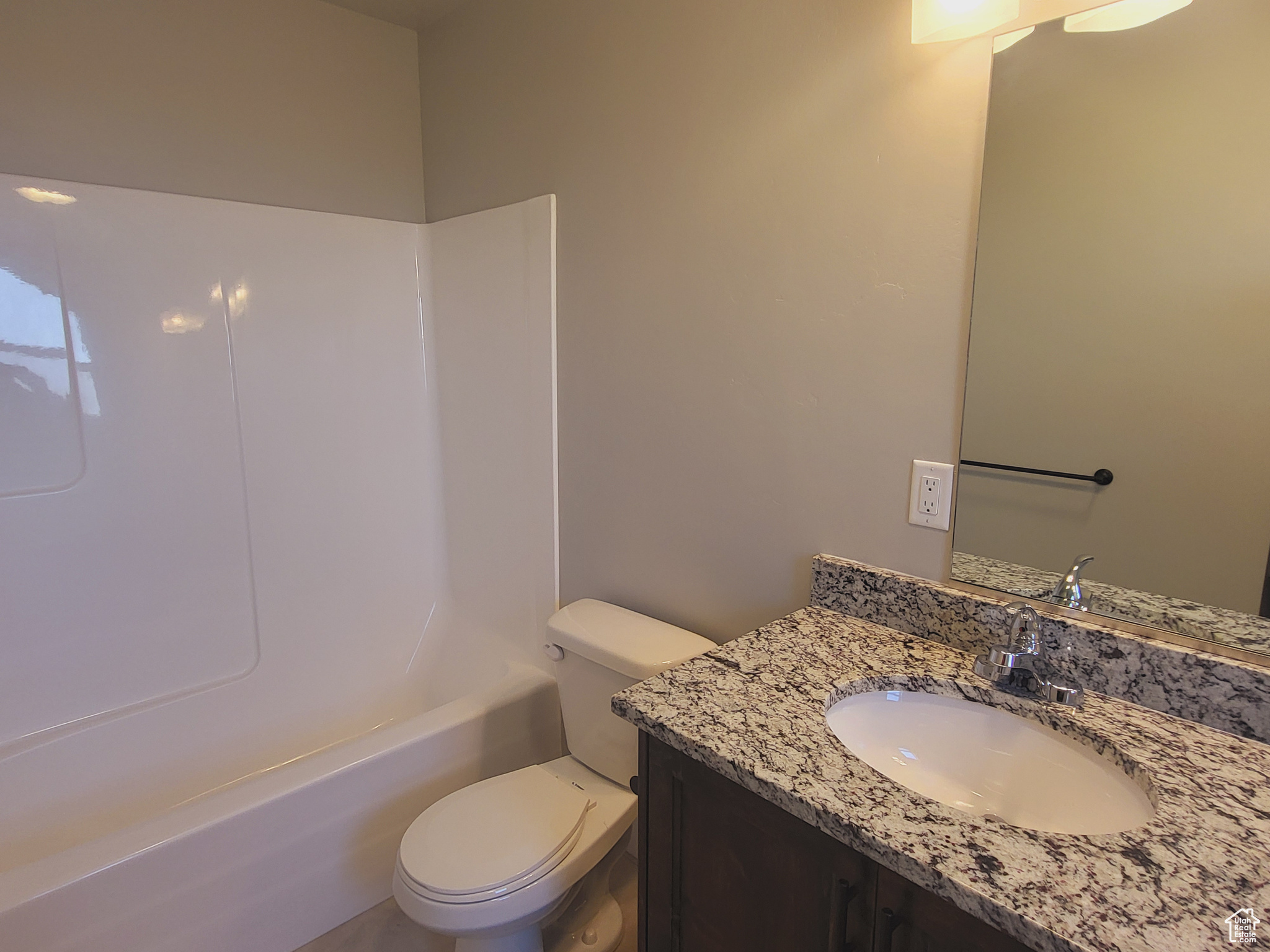 Full bathroom featuring toilet, shower / washtub combination, and vanity