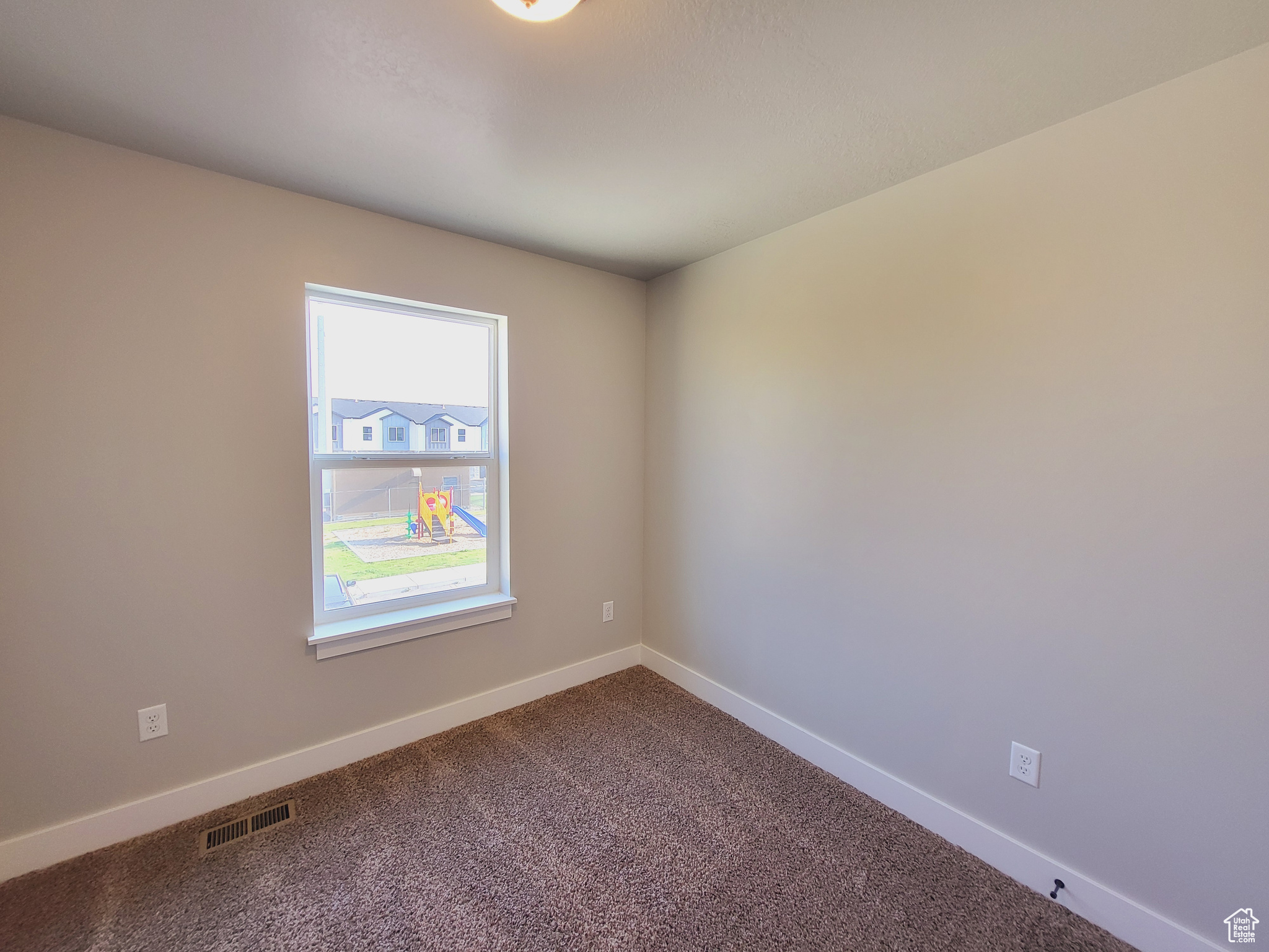 Unfurnished room with carpet