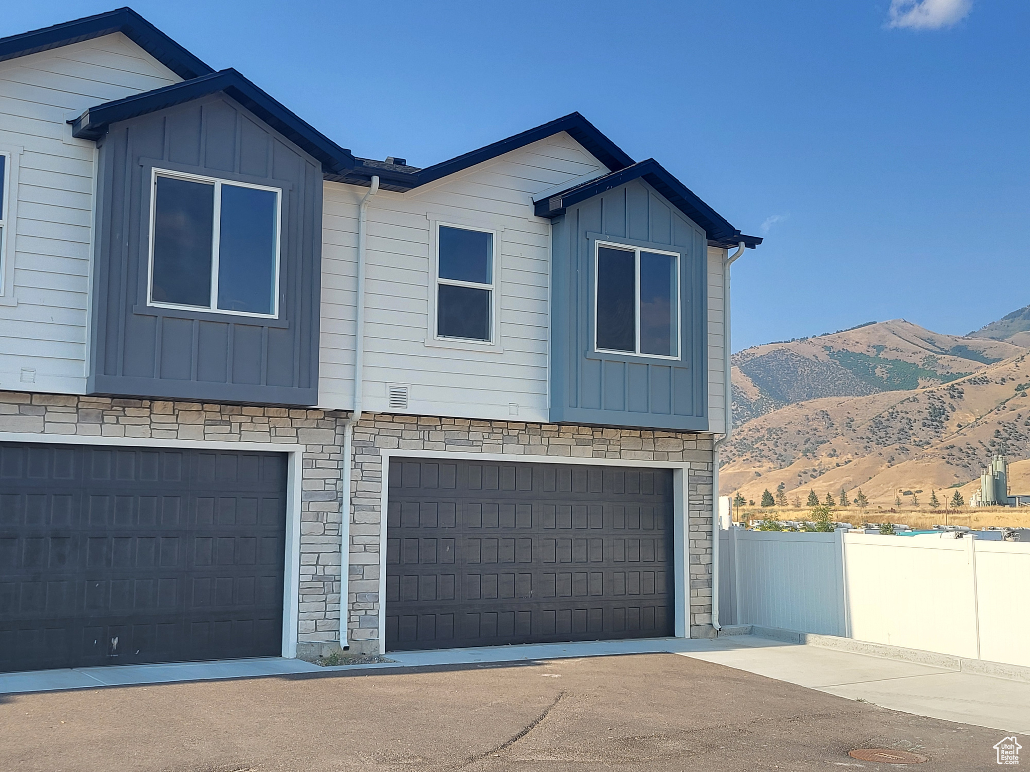 View of front of home with a garage and a mountain view