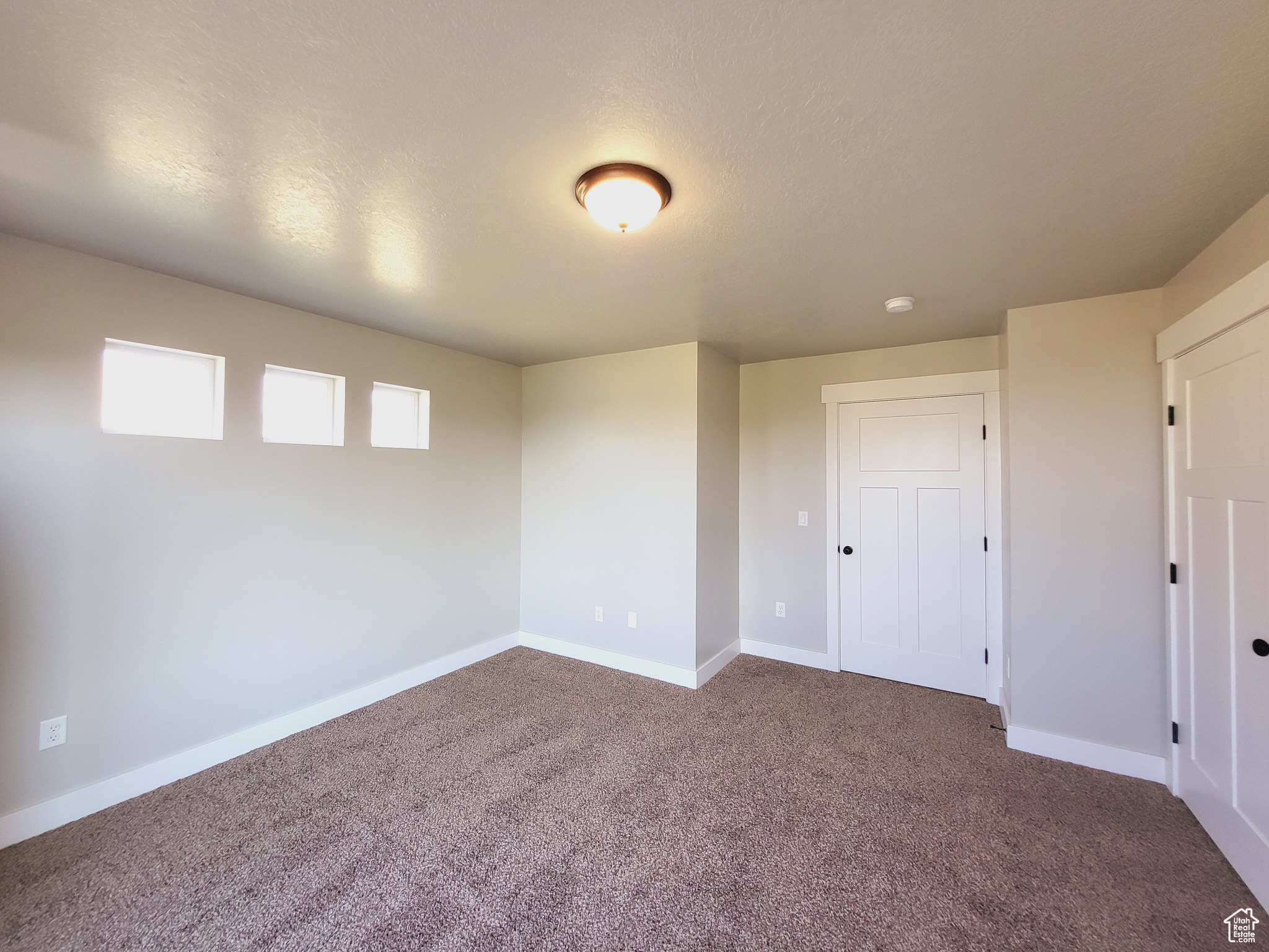 Unfurnished bedroom with carpet floors and a closet