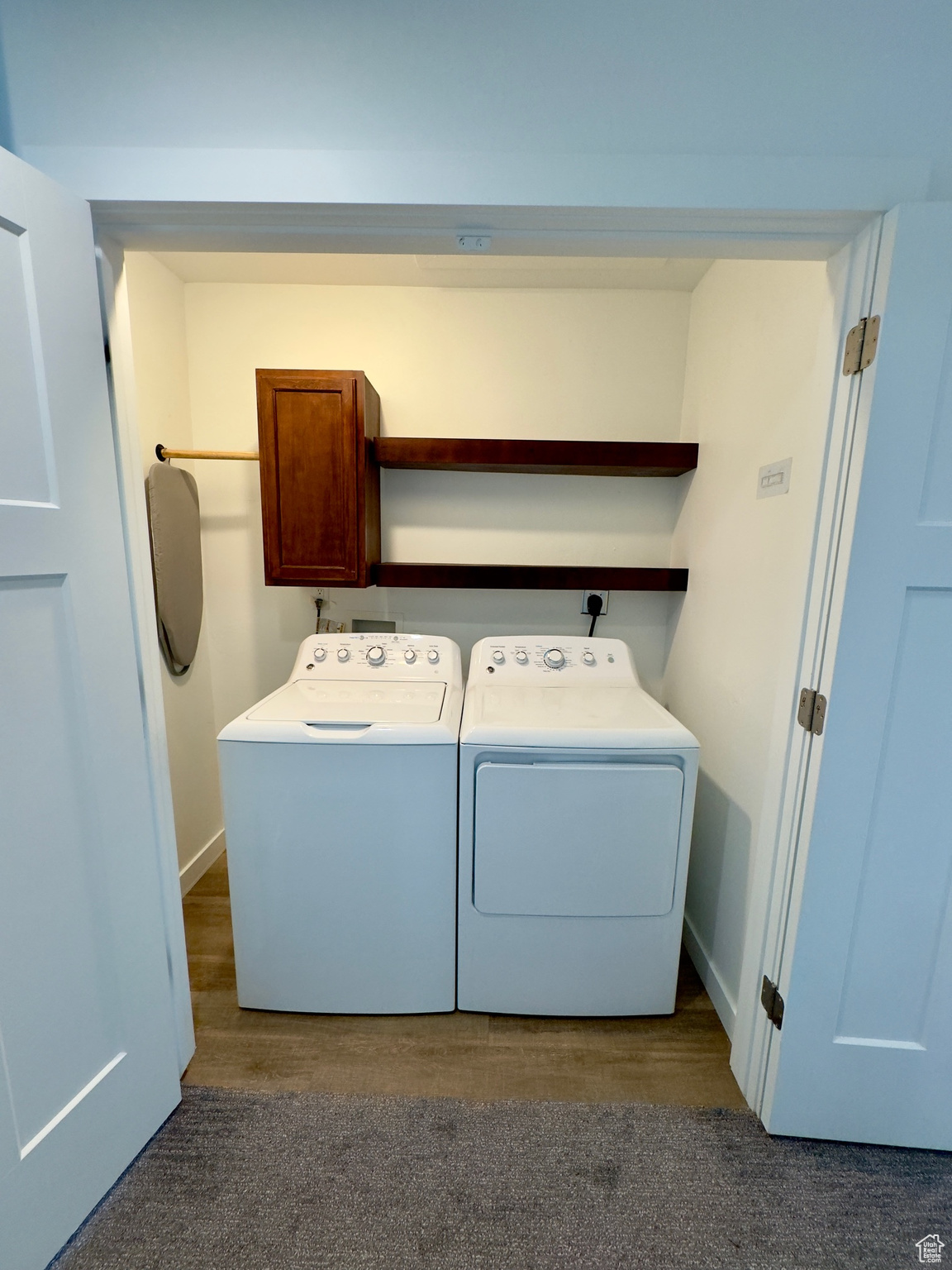 Top floor laundry room with cabinet & shelves