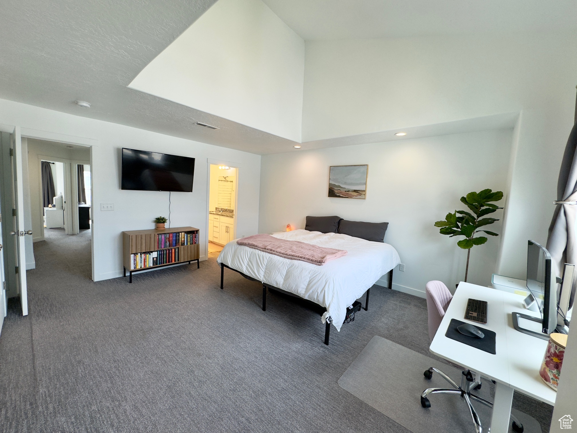 Master bedroom with tall, vaulted ceilings