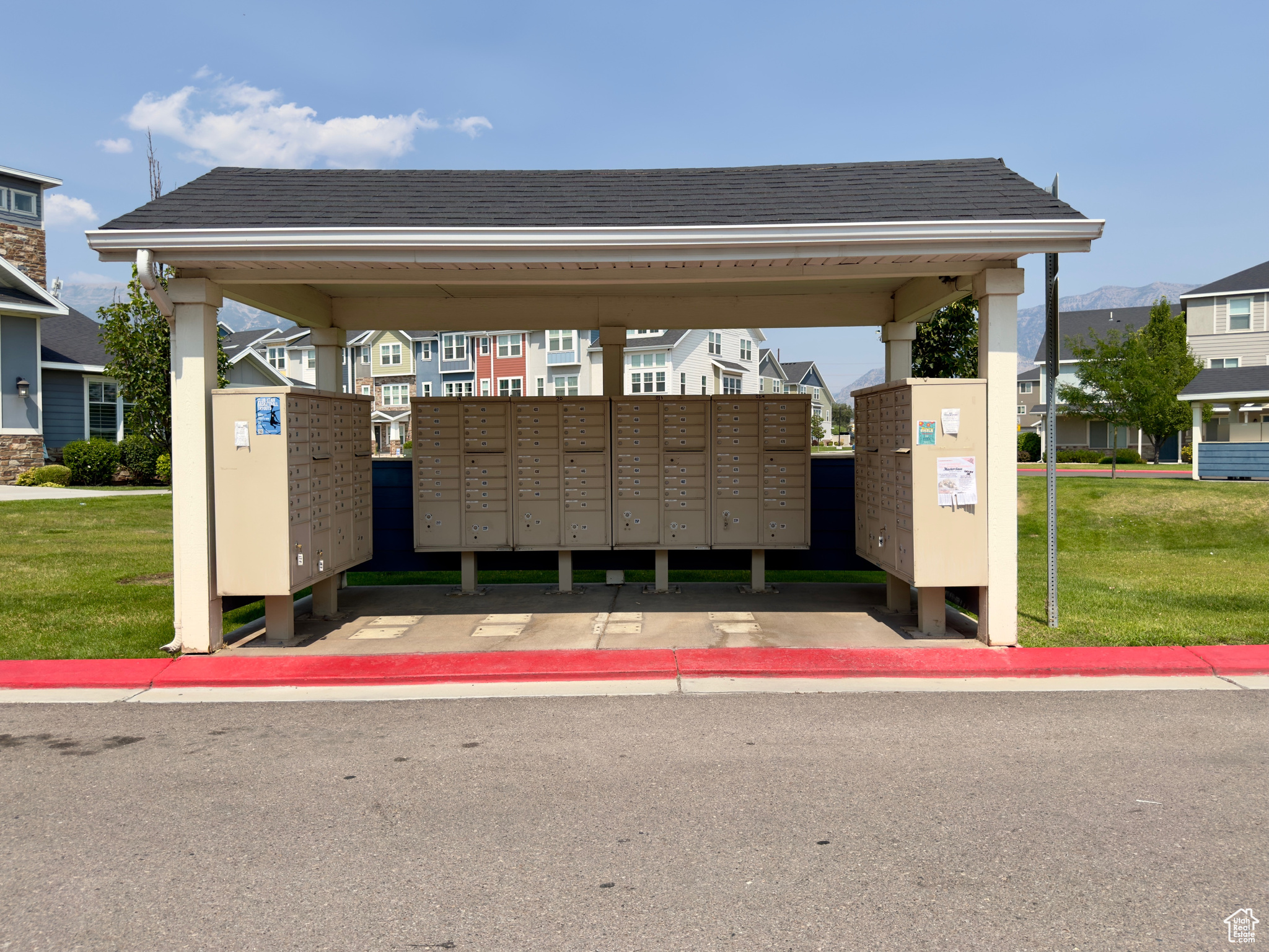 View of community featuring a mail area and a lawn