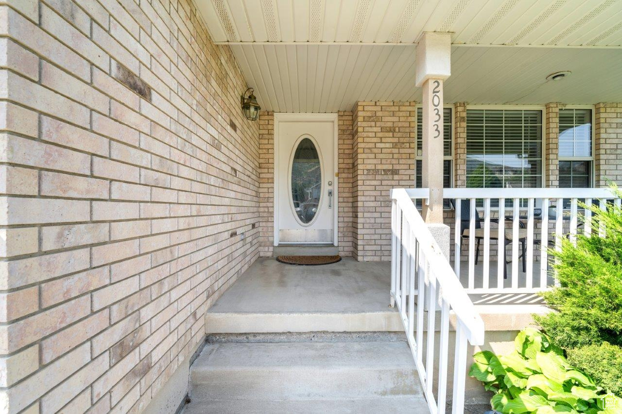 View of exterior entry with a porch