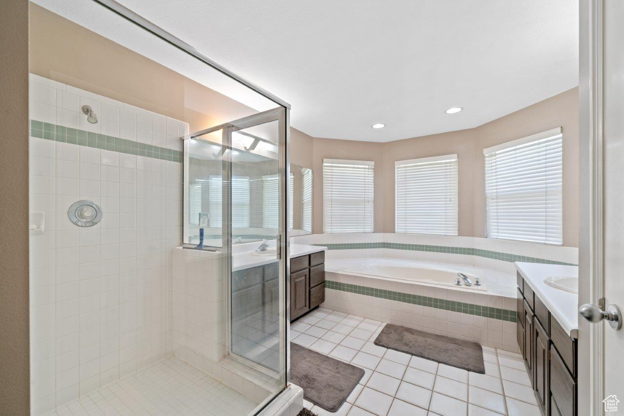 Bathroom with vanity, plus walk in shower, and tile patterned floors