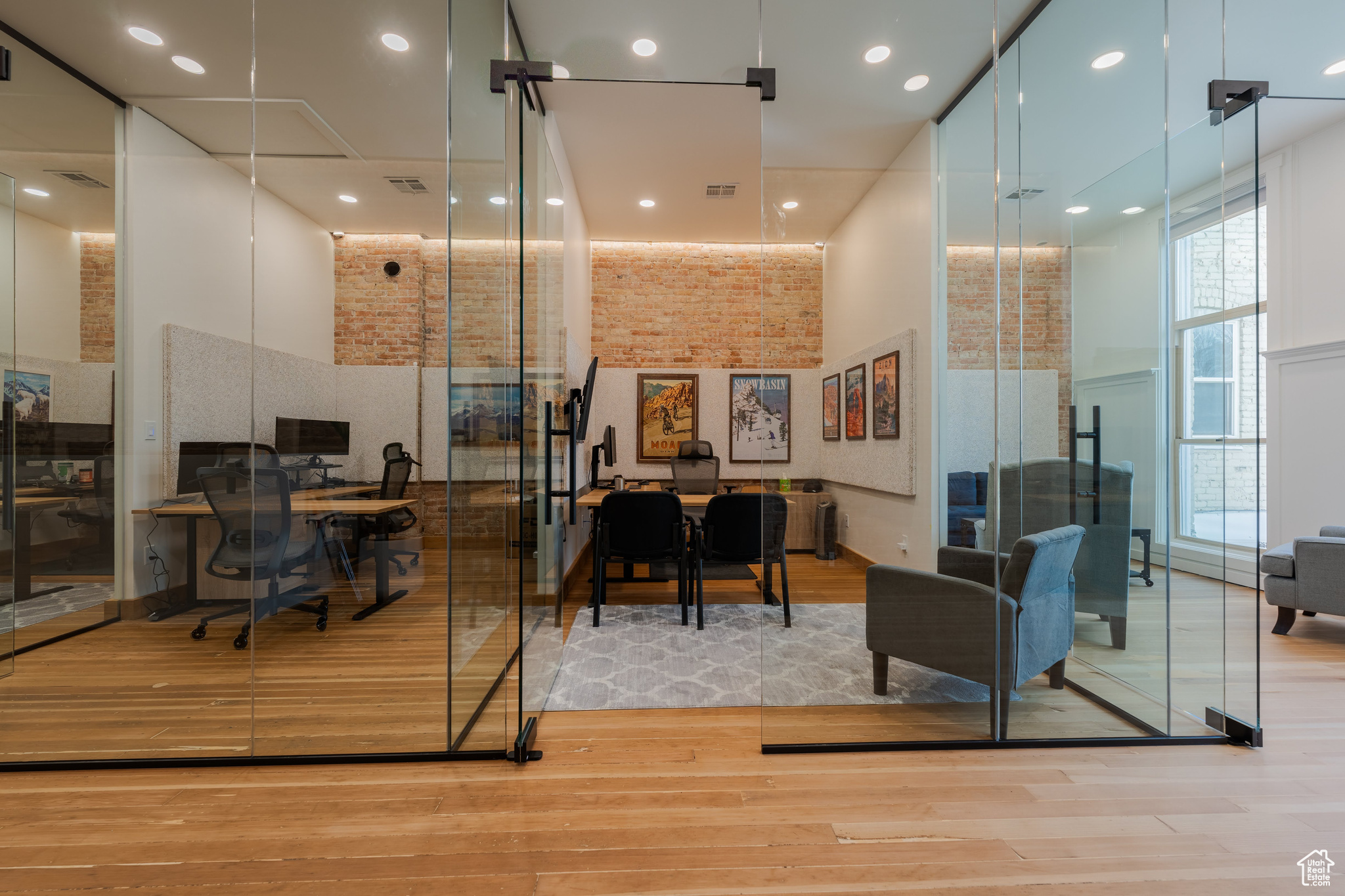 Glass office with lots of natural light and high ceilings.