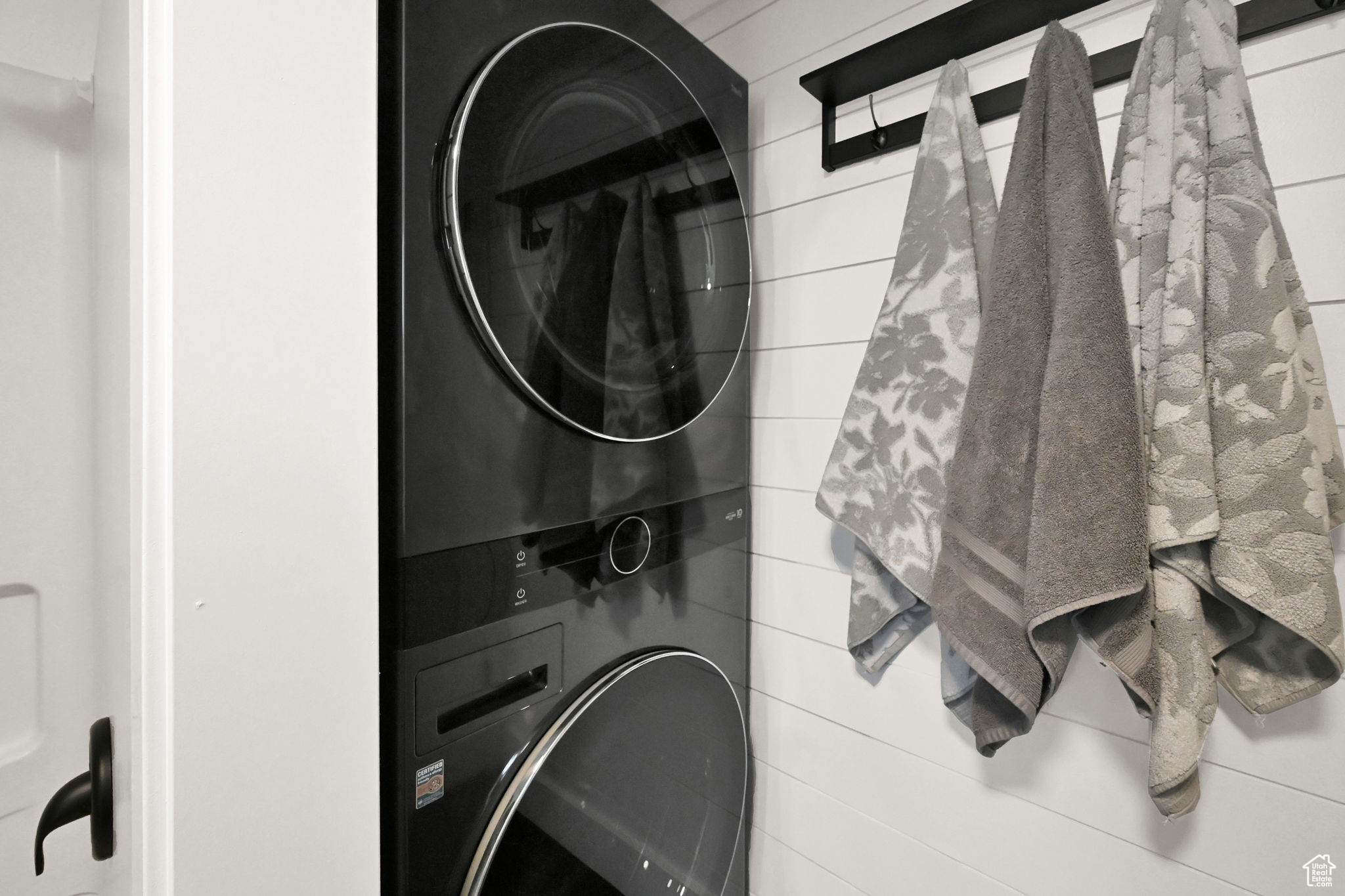 Laundry area with stacked washer and dryer