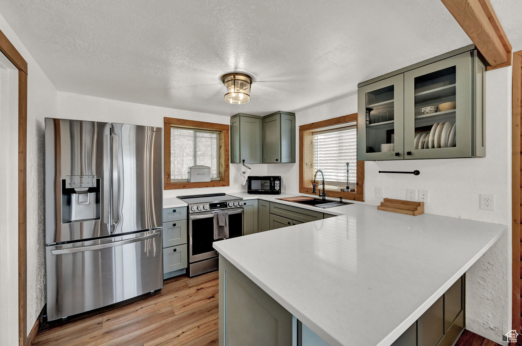 Kitchen featuring sink, a healthy amount of sunlight, kitchen peninsula, and stainless steel appliances