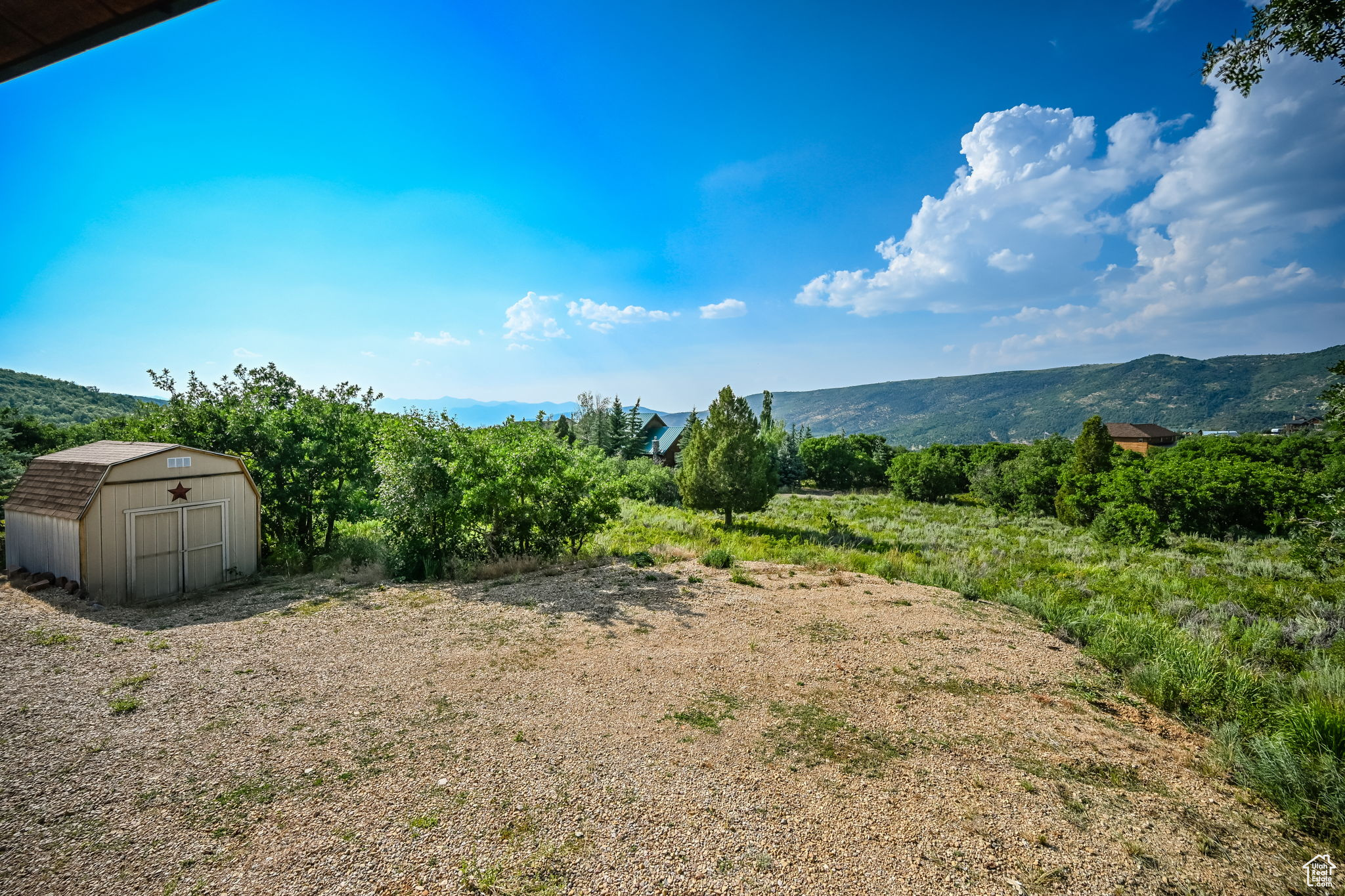 Exterior space featuring a shed and a mountain view