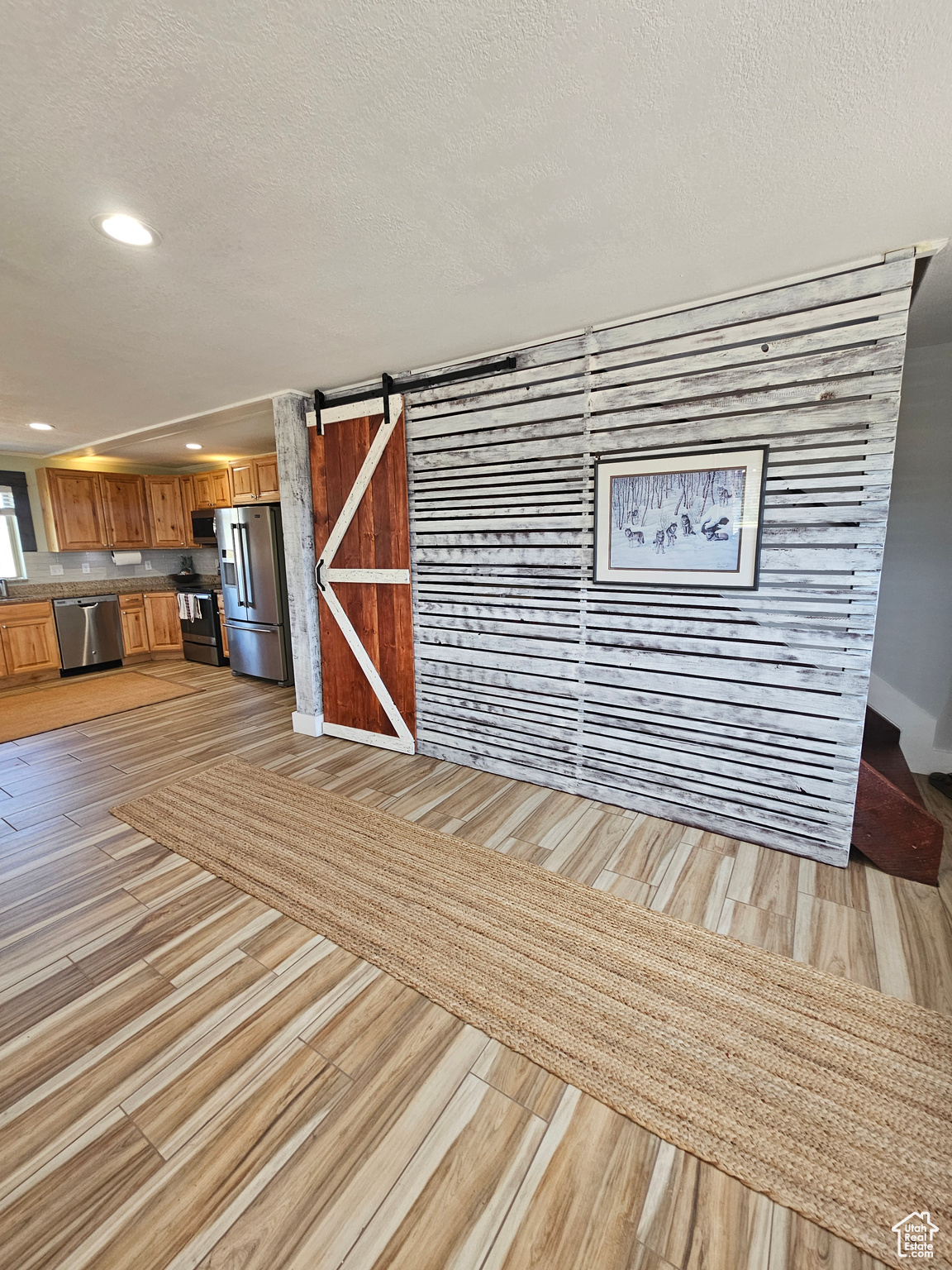 Storage under the stairs with cute barn door & distressed wood-look!