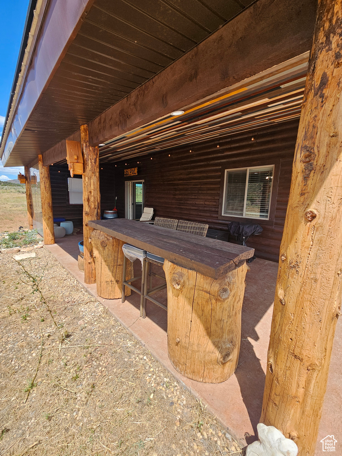 Nice covered patio with beautiful wood & log finishes!