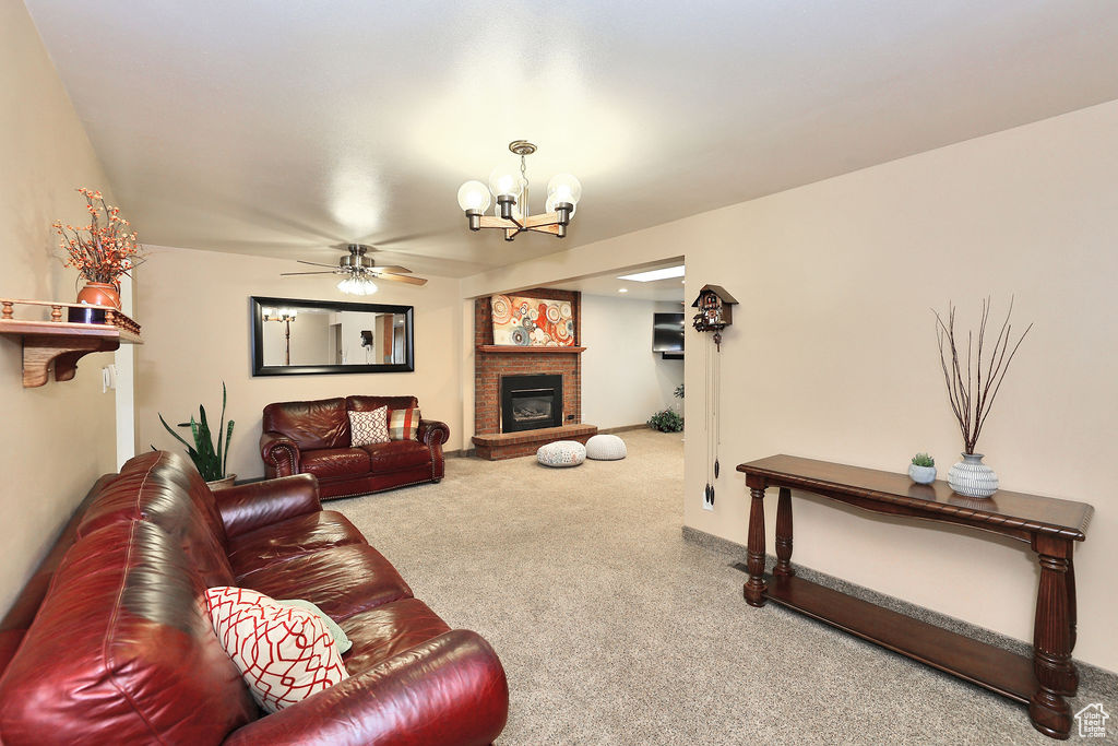 Great room featuring a brick fireplace and ceiling fan with notable mid century chandelier