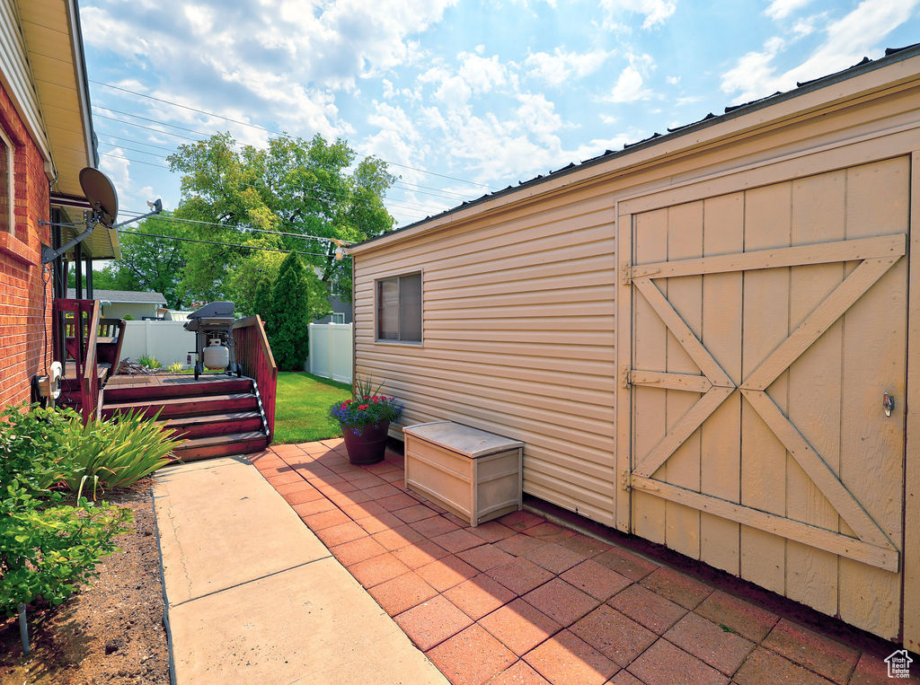 View of patio / terrace featuring an outbuilding and a grill