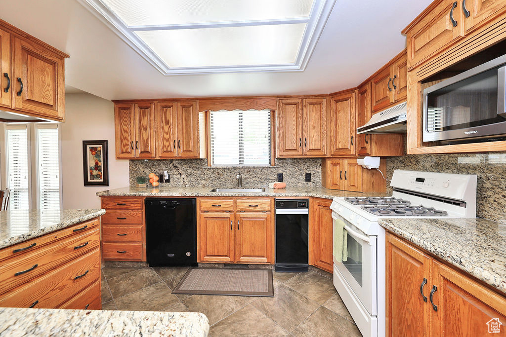 Kitchen featuring  tile patterned flooring, stainless steel microwave, and  gas stovetop