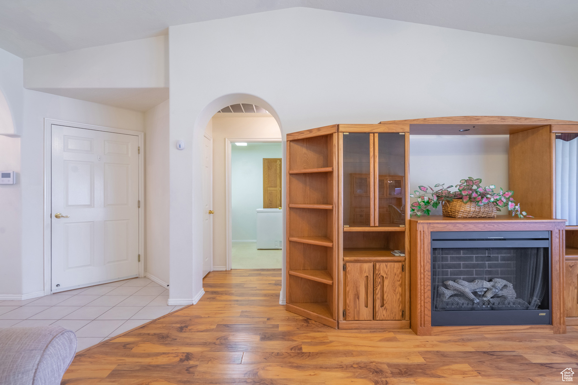 Living room featuring light wood-type flooring and lofted ceiling