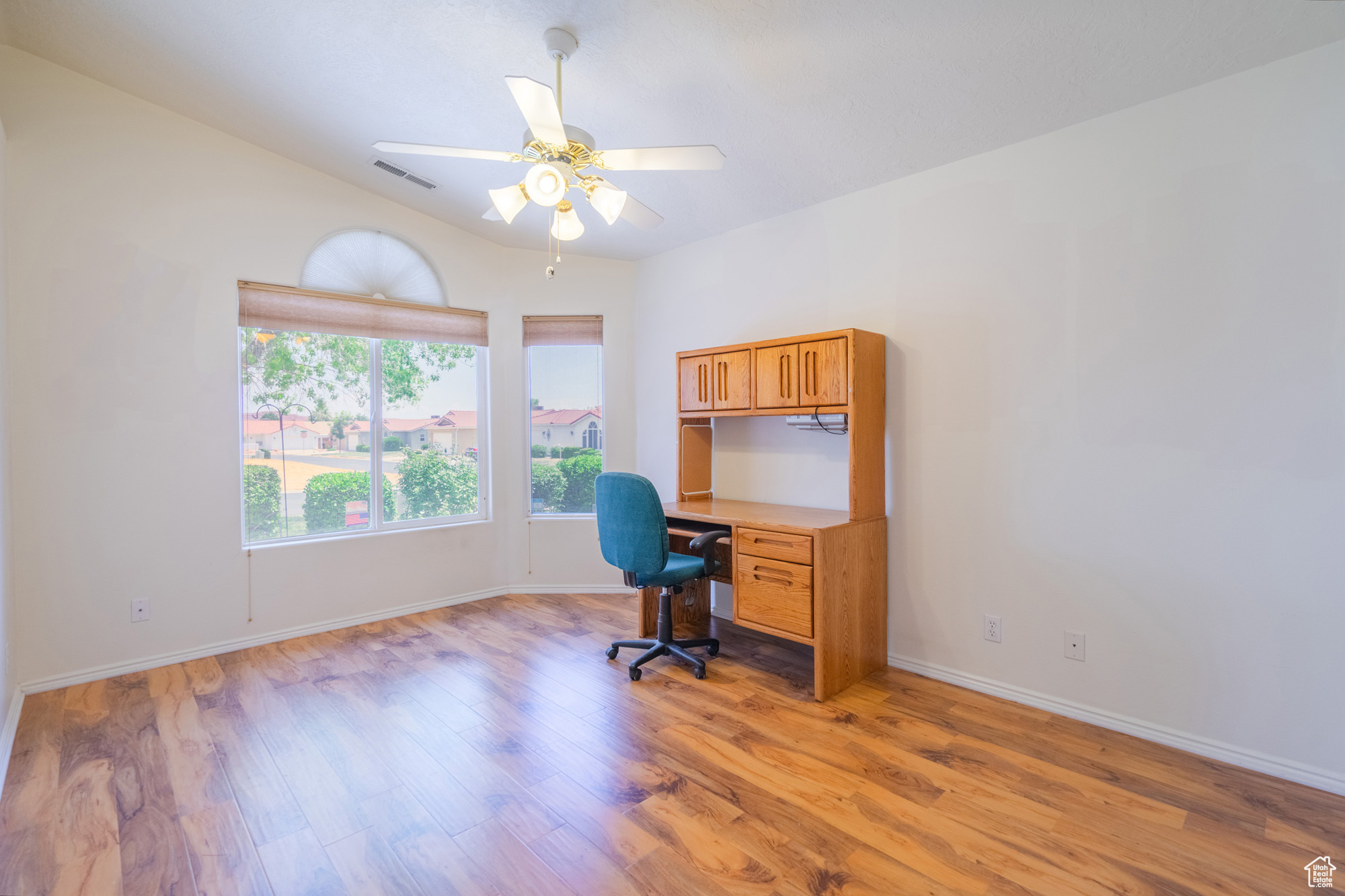 Guest Bedroom/Office area featuring hardwood / wood-style flooring, lofted ceiling, and ceiling fan